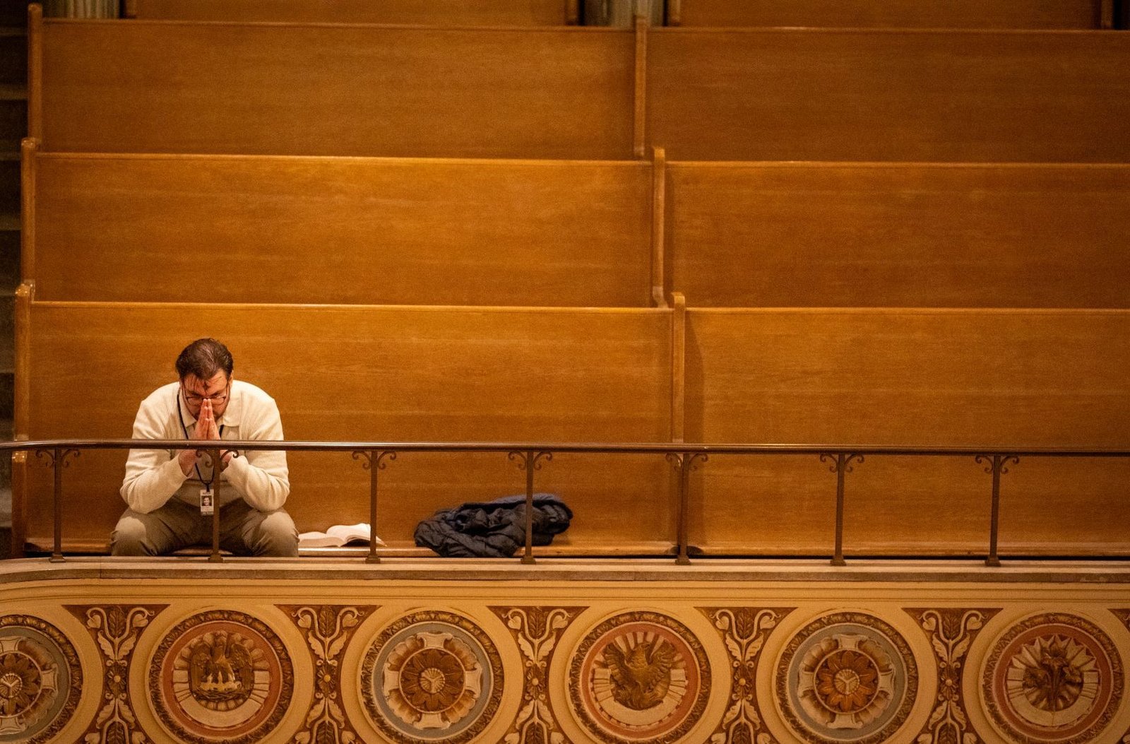 A man prays in the upper level of St. Aloysius Parish in downtown Detroit on Ash Wednesday, Feb. 18.