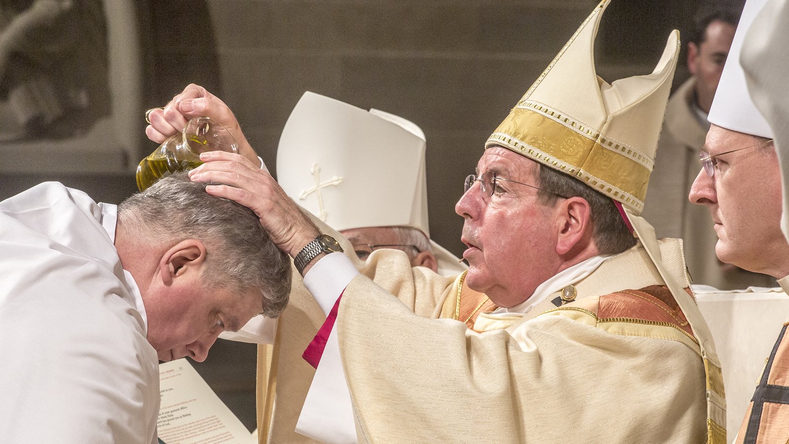 Archbishop Vigneron anoints the head of Auxiliary Bishop Gerard W. Battersby with chrism oil during the episcopal ordination of Bishop Battersby and Bishop Robert J. Fisher on Jan. 25, 2017. The announcement of Bishop Battersby and Bishop Fisher's appointment came three days after the close of Synod 16. (Larry A. Peplin | Detroit Catholic file photo)