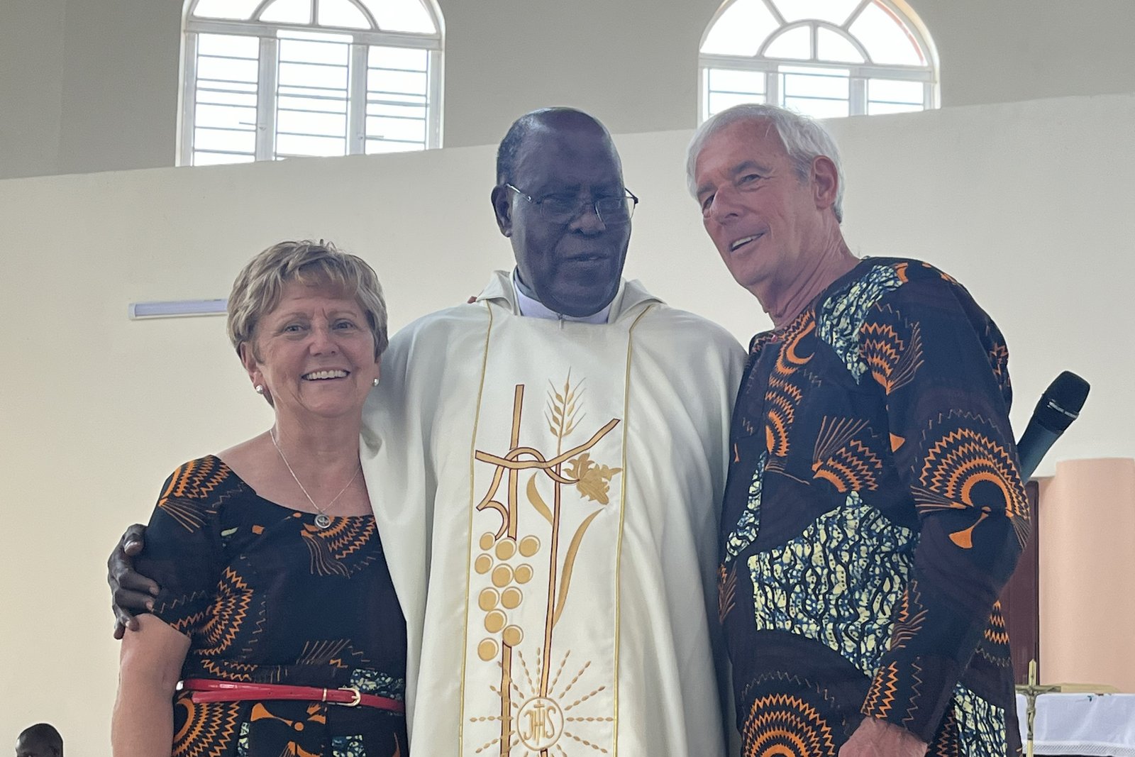 Nancy and Paul Berrigan are pictured with Msgr. John Kauta, a priest from Uganda whose homily while visiting St. Fabian Parish in Farmington Hills in 2005 inspired the couple to found John Paul Secondary School, which today educates more than 800 students each year.