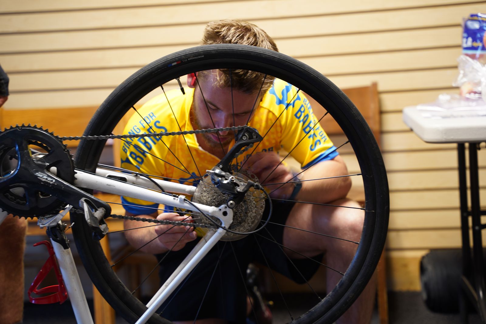 A Biking for Babies team member inspects the rear tire of a bike before beginning the trek. Biking for Babies teams start their rides at 6 a.m., getting most the day's miles in before the hottest parts of the day.