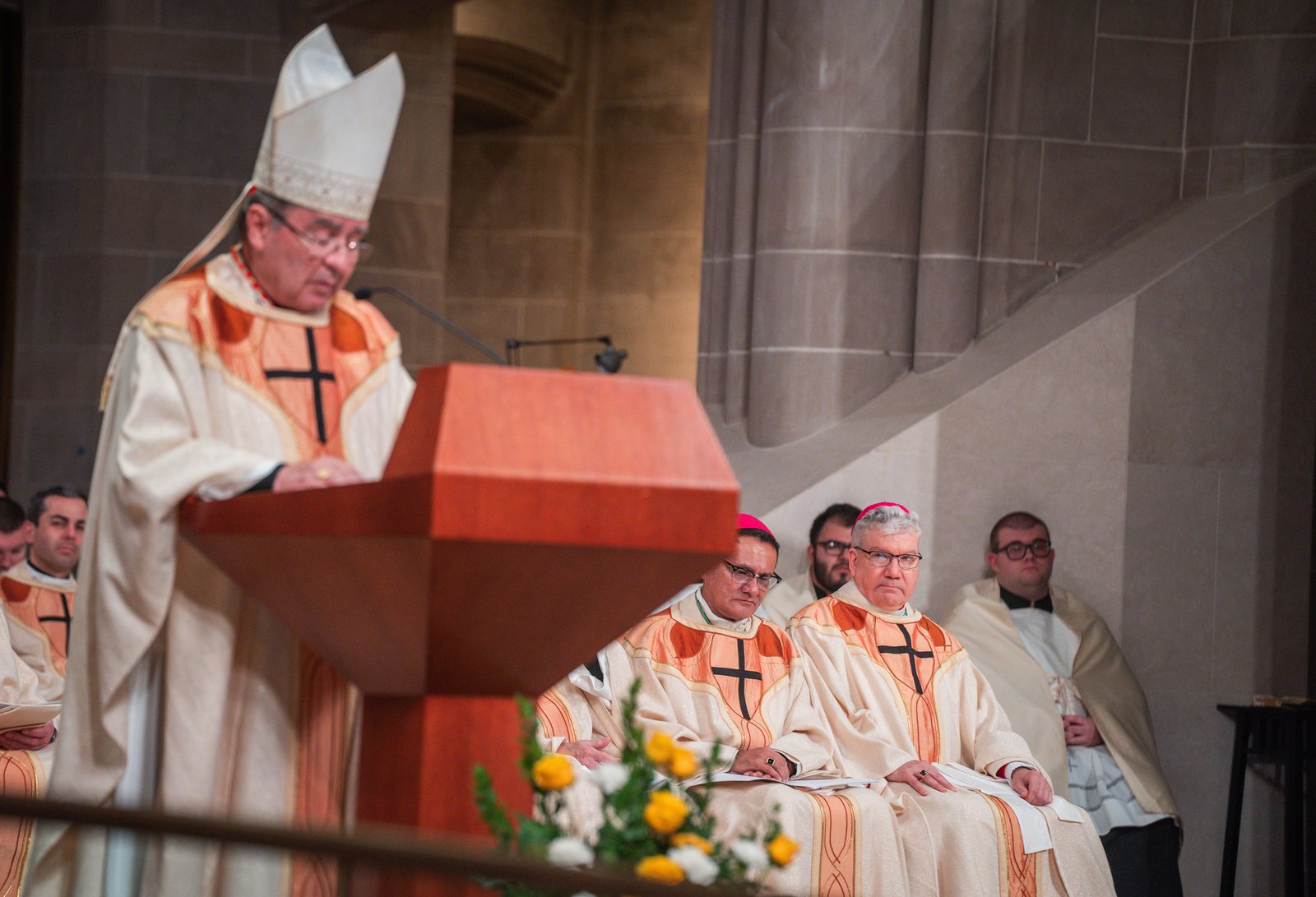 Bishop Monforton, right, listens as Cardinal Christophe Pierre, apostolic nuncio to the United States, reads the proclamation from Pope Francis assigning him to a new ministry in the Archdiocese of Detroit.