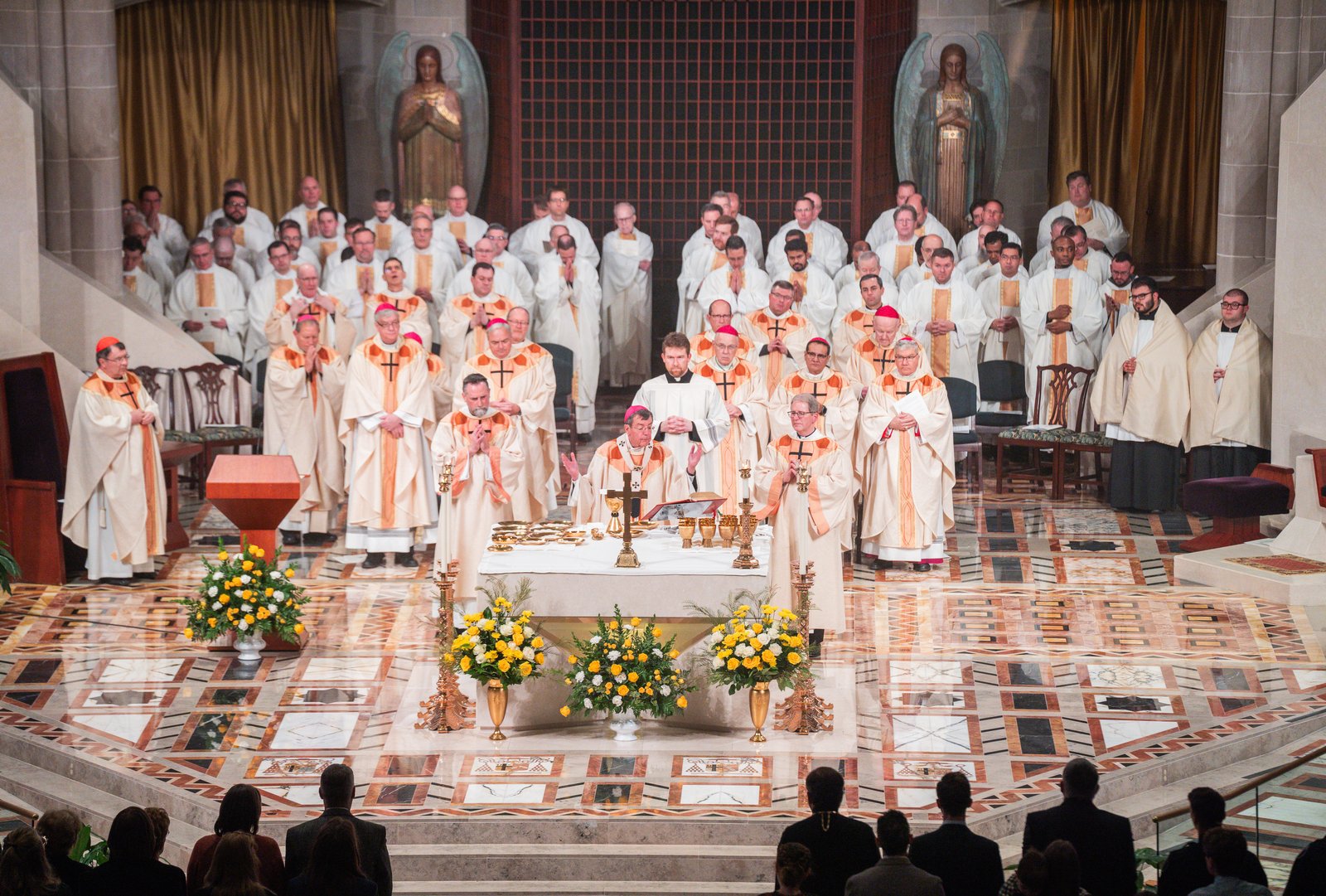 Archbishop Allen H. Vigneron, surrounded by bishops, priests and deacons of the Archdiocese of Detroit, offers the holy Eucharist at the culmination of the Mass. Bishop Monforton pledged fidelity to Archbishop Vigneron's leadership of the archdiocese and said he looks forward to serving alongside Detroit's other auxiliary bishops.