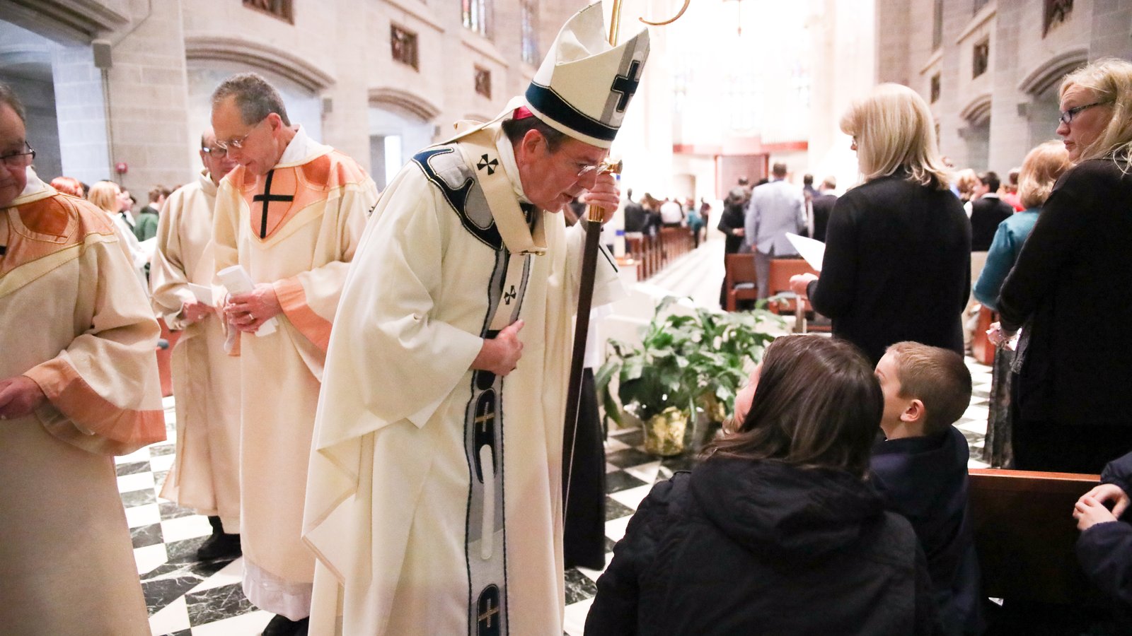 Archbishop Vigneron stops to talk to a young student during the annual Catholic Schools Week Mass at the Cathedral of the Most Blessed Sacrament on Jan. 31, 2018. (Naomi Vrazo | Detroit Catholic file photo)
