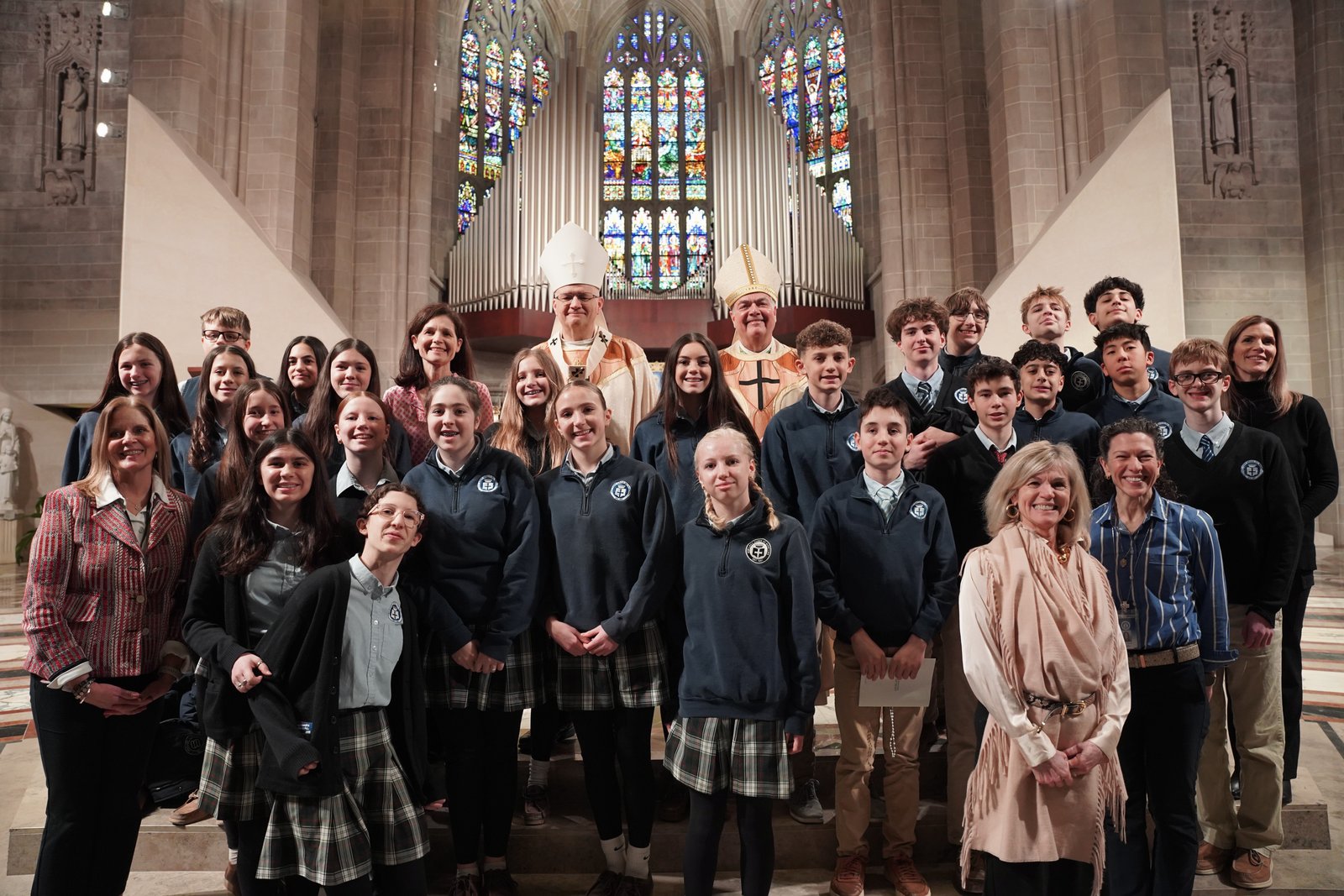 Archbishop Edward J. Weisenburger and Auxiliary Bishop Robert J. Fisher pause for photos with students and teachers Jan. 29 after the annual Catholic Schools Week Mass at the Cathedral of the Most Blessed Sacrament in Detroit. Students from across the archdiocese gathered to celebrate Catholic Schools Week, a culmination of all the celebrations happening in Catholic schools throughout the week. (Photos by Izzy Cortese | Detroit Catholic)