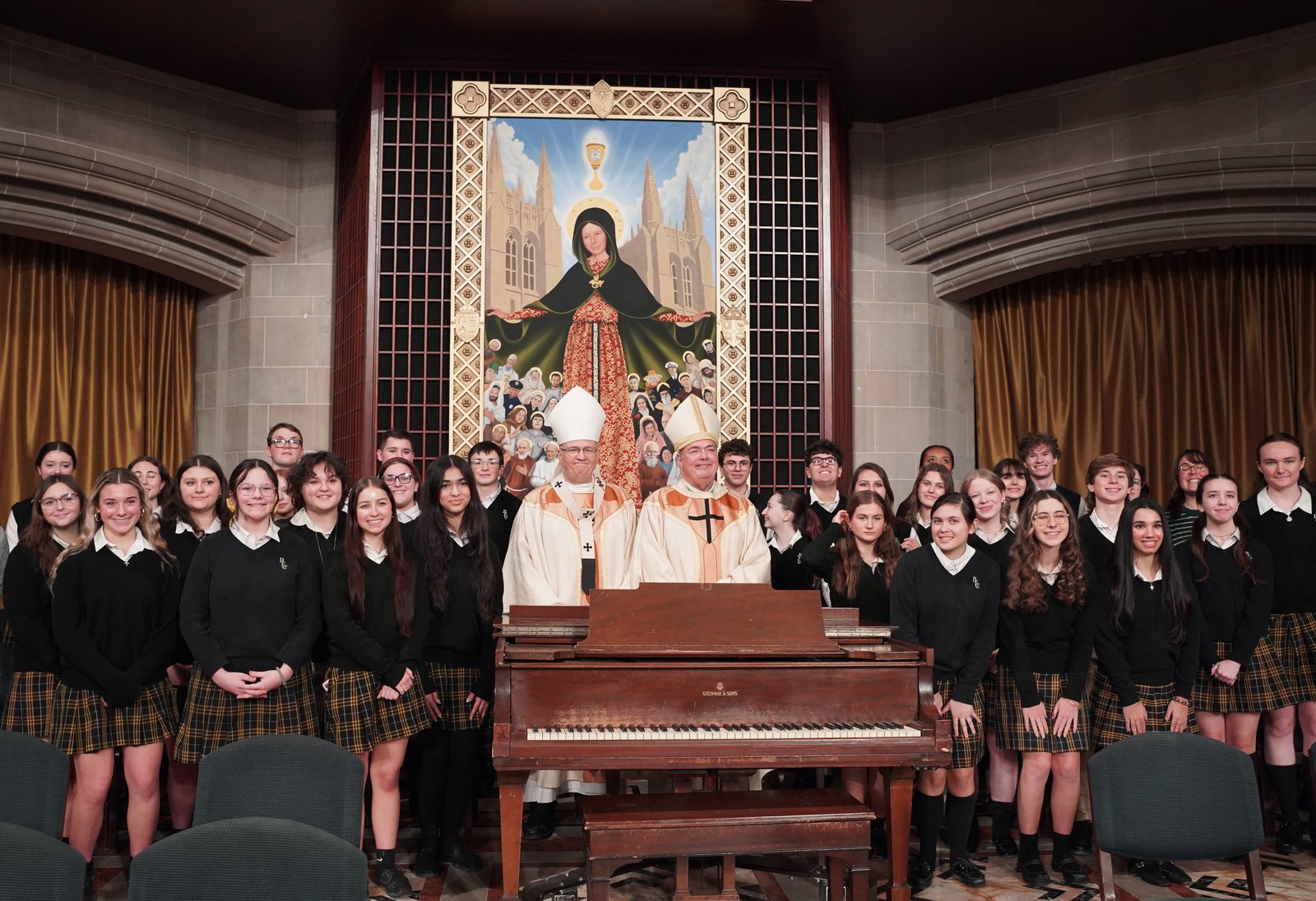 Archbishop Weisenburger and Bishop Fisher take a group photo with students from Bishop Foley High School in Madison Heights, who provided the musical setting for the Catholic Schools Week Mass.