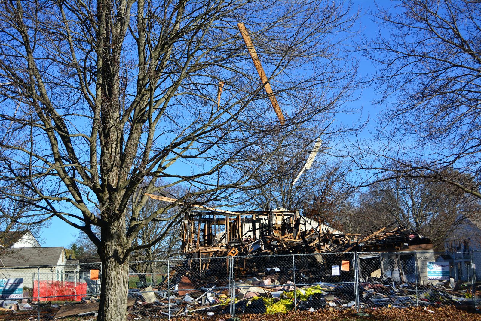 Pieces of wood hang from a tree near a condominium that exploded in Orion Township on Nov. 19. Many of the residents of the Keatington New Town Association condominium complex have been evacuated from their homes as authorities continue to assess the safety of the remaining units.