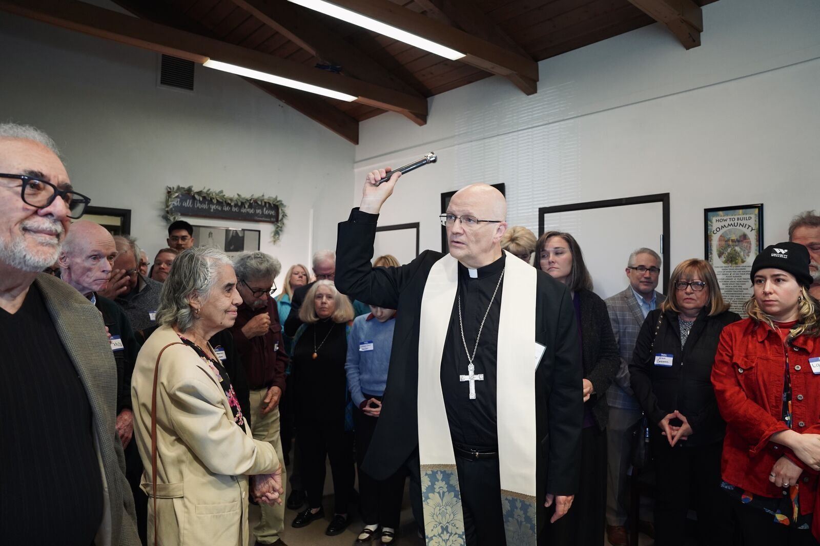 Archbishop Weisenburger blesses the Cabrini Clinic during its rededication on its 75th anniversary. Archbishop Weisenburger thanked the staff and volunteers for "serving Christ" in the poor who seek care at the clinic.