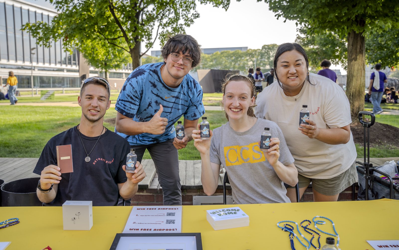 Left to right, Victor Fenik, J.P. Ledermann, Jocelyn Reiter and Anna Picasso distribute bottles of holy water to new and returning students during the involvement fair Aug. 26, 2024, at the College for Creative Studies in Detroit. Members of Detroit Catholic Campus Ministry distributed holy water at the start of the academic year at local colleges and universities. (Photos by Valaurian Waller | Detroit Catholic)