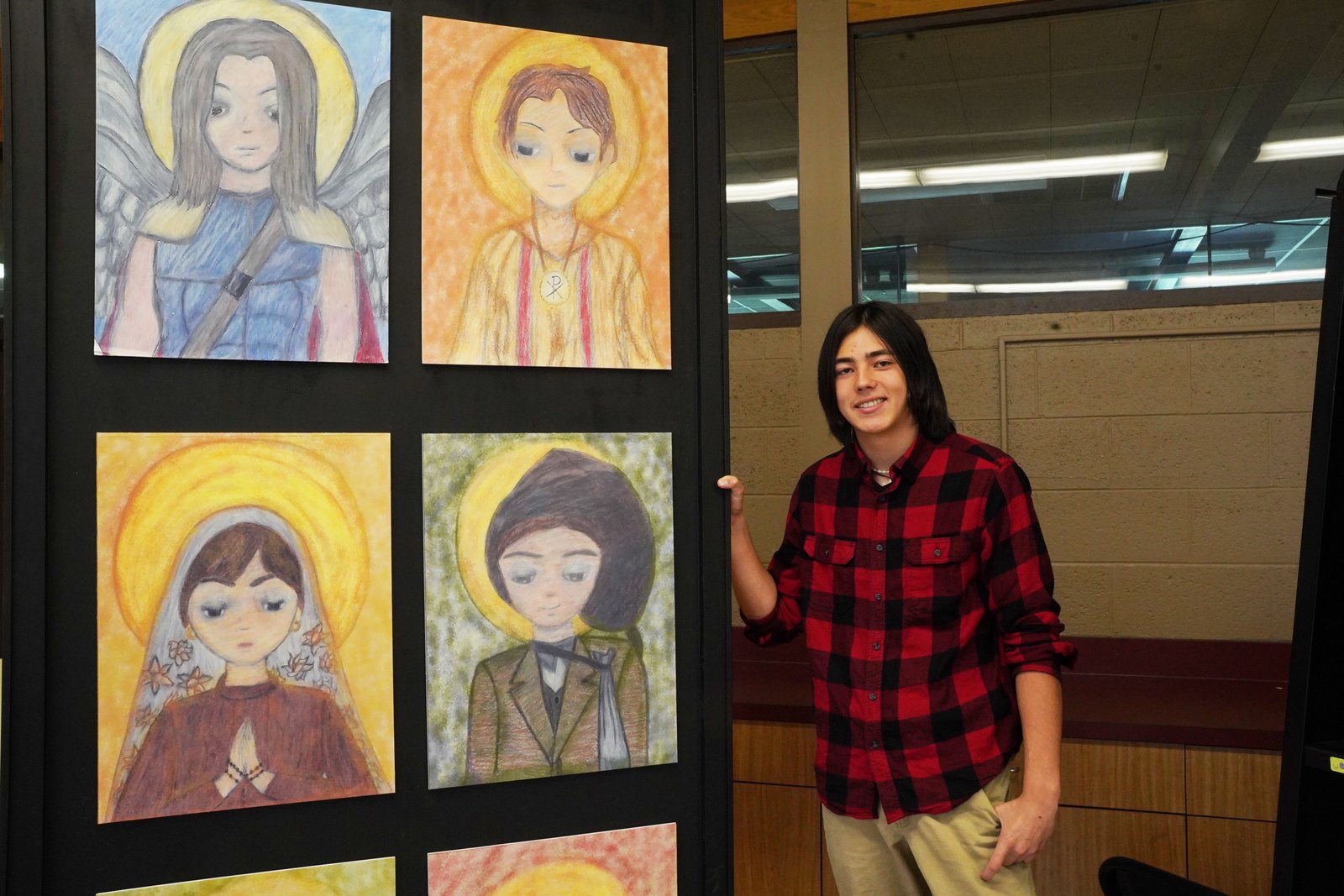 Nick Narduzzi's drawing of young saints is a combination of classic Christian iconography and manga-style anime. (Daniel Meloy | Detroit Catholic)