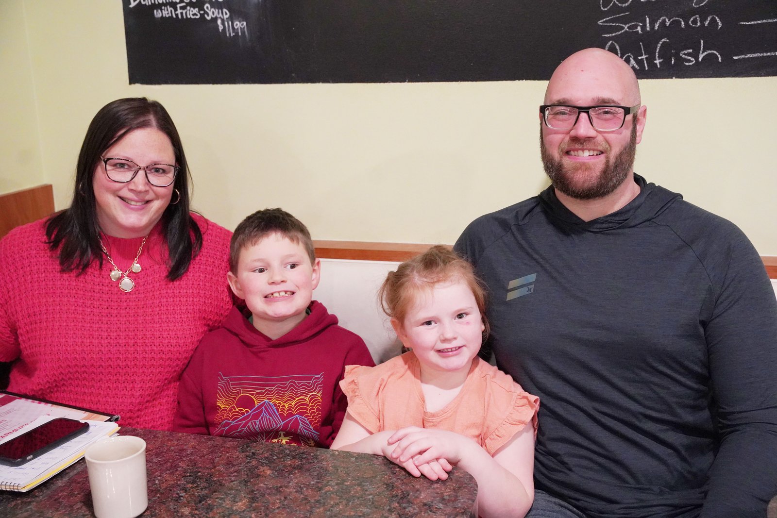 Charlie Nicholls with his mom, Nicole, sister, Reagan, and dad, Keith. Ever since Charlie expressed an interest in being baptized and entering the Catholic Church, the family has been going to Mass weekly, usually sitting in the front pew so Charlie can pay close attention to the priest celebrating Mass. (Daniel Meloy | Detroit Catholic)