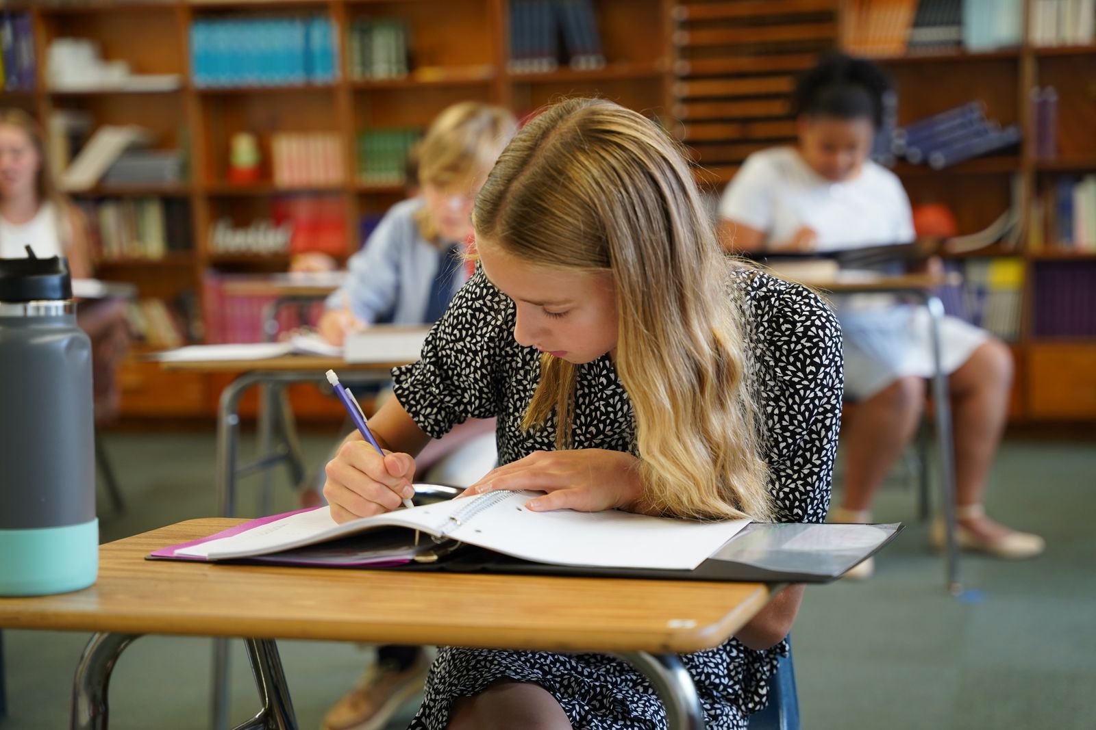 A young learner completes her assignment as part of St. Patrick School's new classical curriculum. The tight-knit rural community's support of St. Patrick School has allowed the school to thrive over the centuries, one of the longest-running Catholic schools in Michigan. (Daniel Meloy | Detroit Catholic)