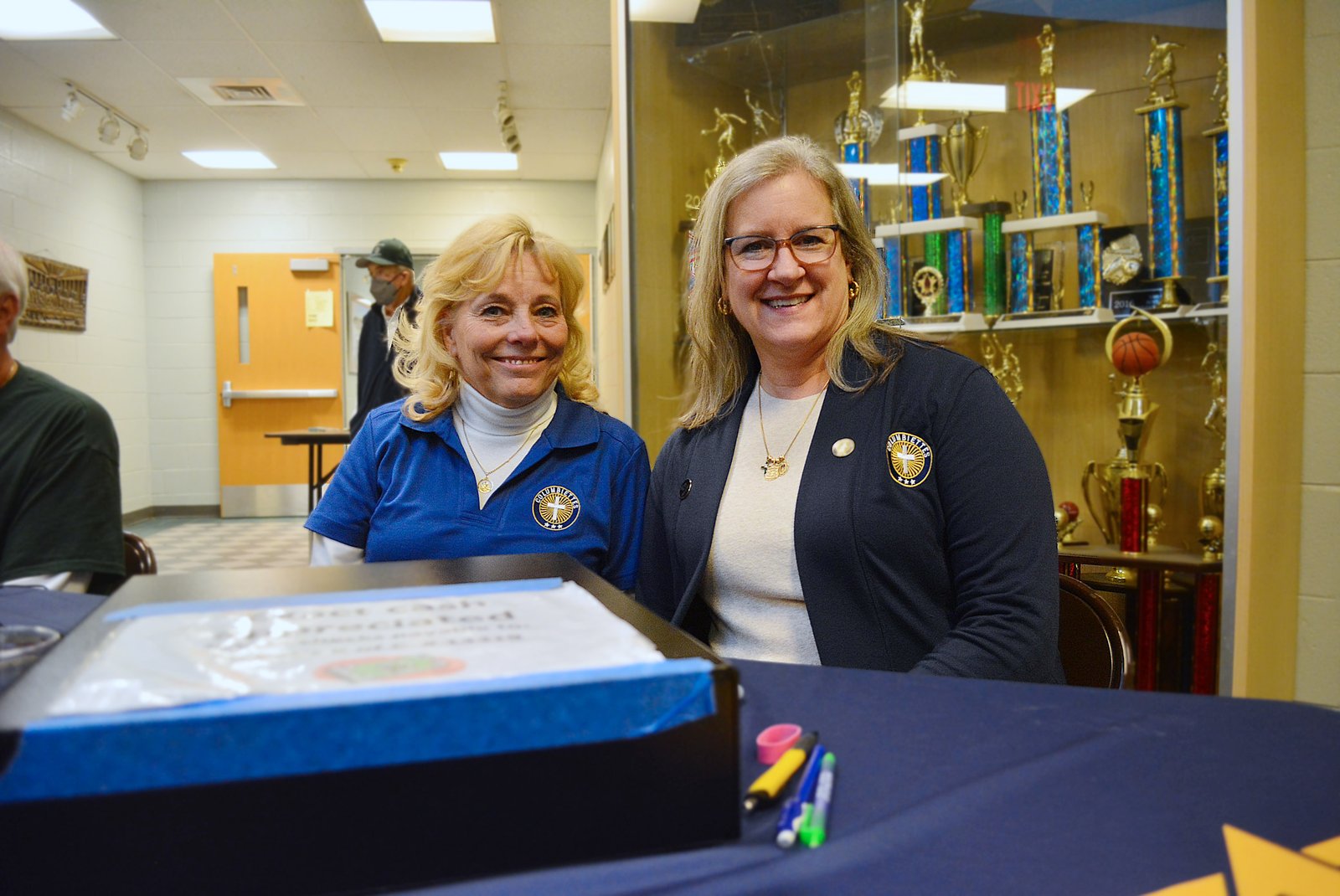 Columbiettes Jill Koterba, left, and Jennifer Fitzgerald work the ticket booth during St. Patrick's fish fry on Feb. 24.