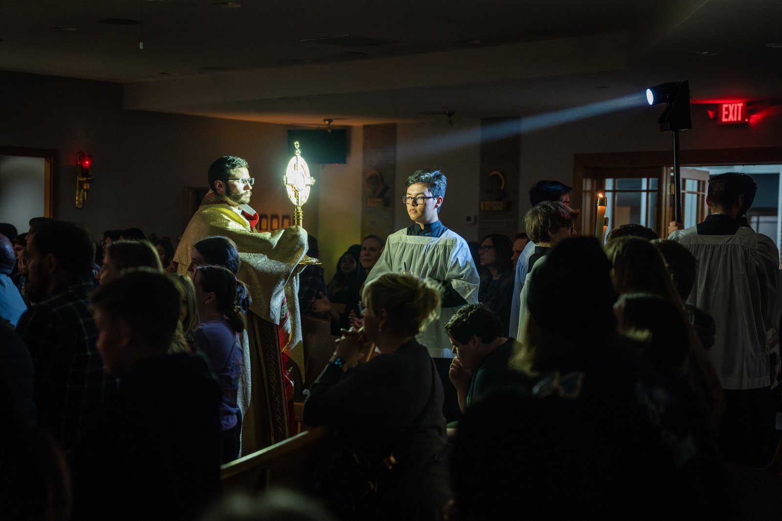 Fr. Schupbach processes with the Eucharist in the monstrance throughout Christ, Our Light! Parish, allowing for people to adore the Sacrament up close.