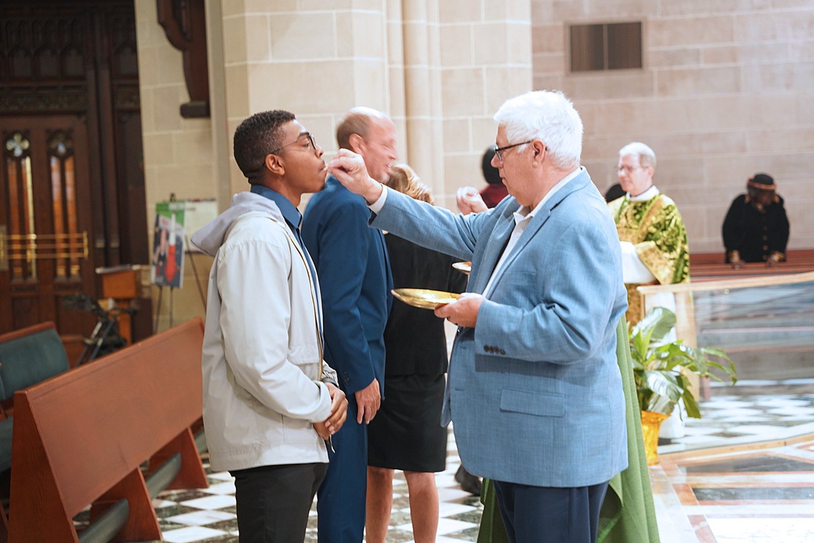 A man receives Communion during the Mass for the Sanctity of Life. The archbishop noted that the Catholic Church's call to protect the dignity of life from conception to natural death stems from Christ's love for all, rooted in the creation of humanity in God's image.