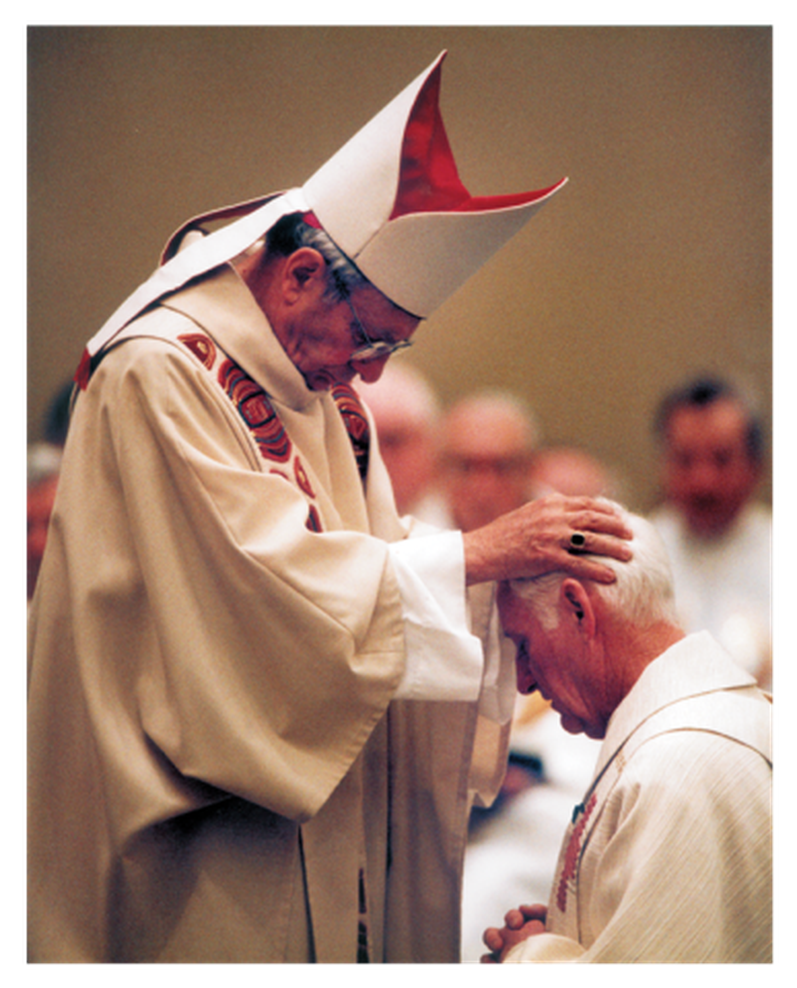 Cardinal Adam Maida lays hands on Bishop Carl Mengeling during his ordination as Bishop of Lansing on January 25, 1996. (photo courtesy of the Diocese of Lansing)