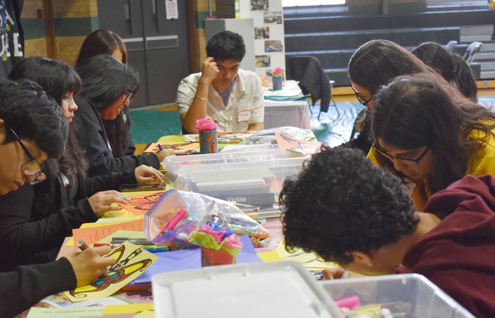 Students create butterfly art, with words of support for immigrants, that will be sent to their elected officials and religious leaders.