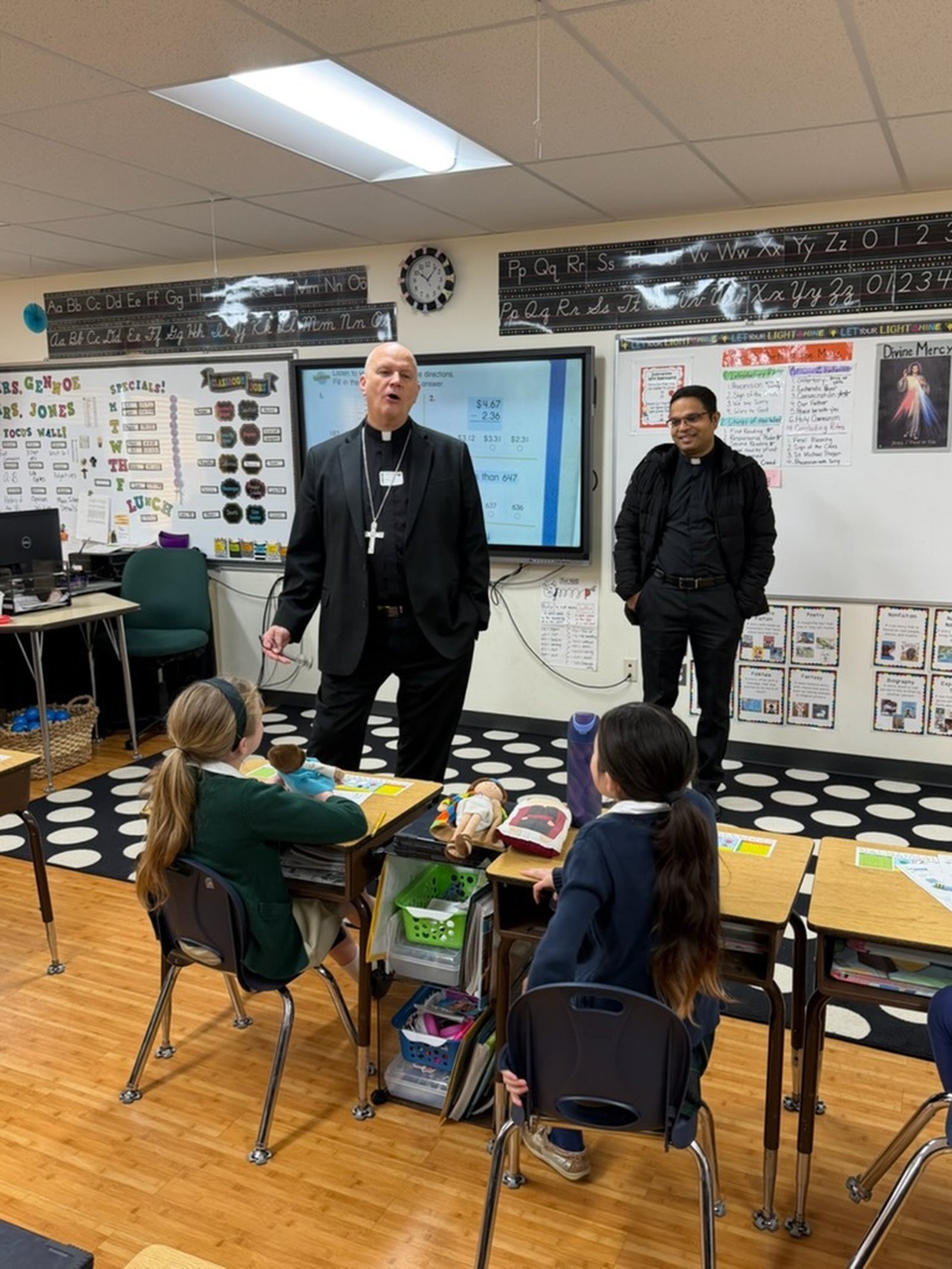 Archbishop Weisenburger and Fr. Rebello answer questions from curious students.