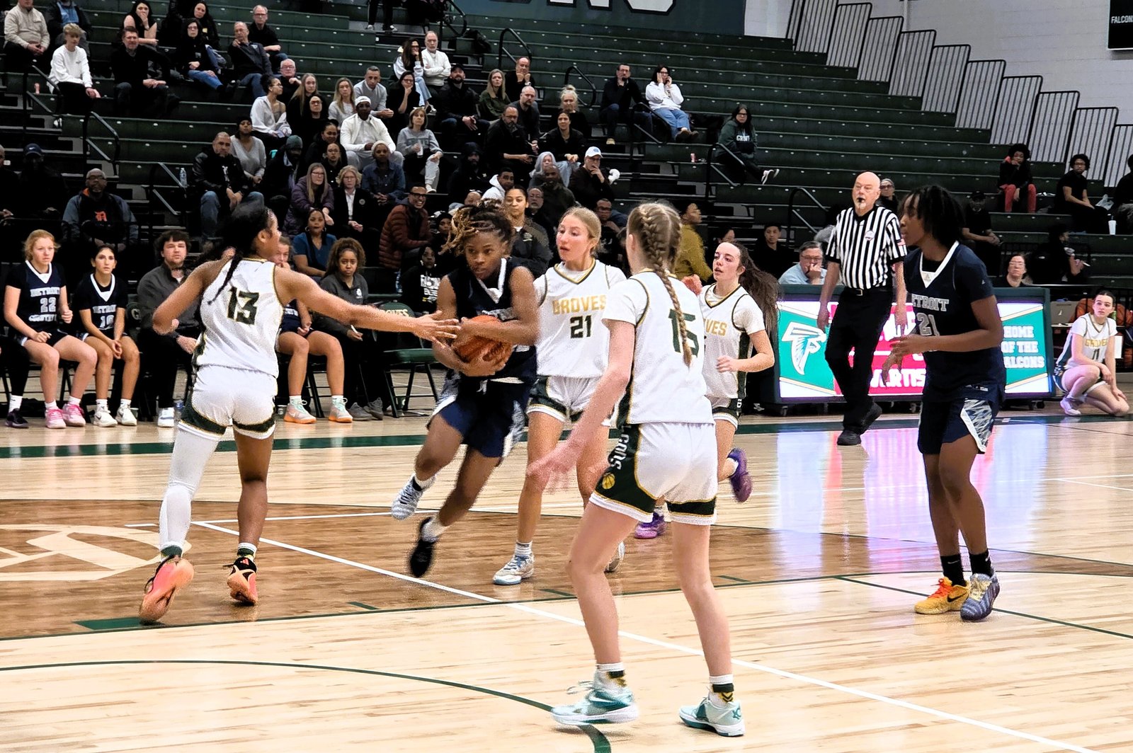 A Country Day ball handler looks for an open teammate in the Yellowjackets’ Feb. 10 contest at Birmingham Groves, won by Country Day, 80-64. Effective next season, Country Day will compete as a member of the Catholic High School League.