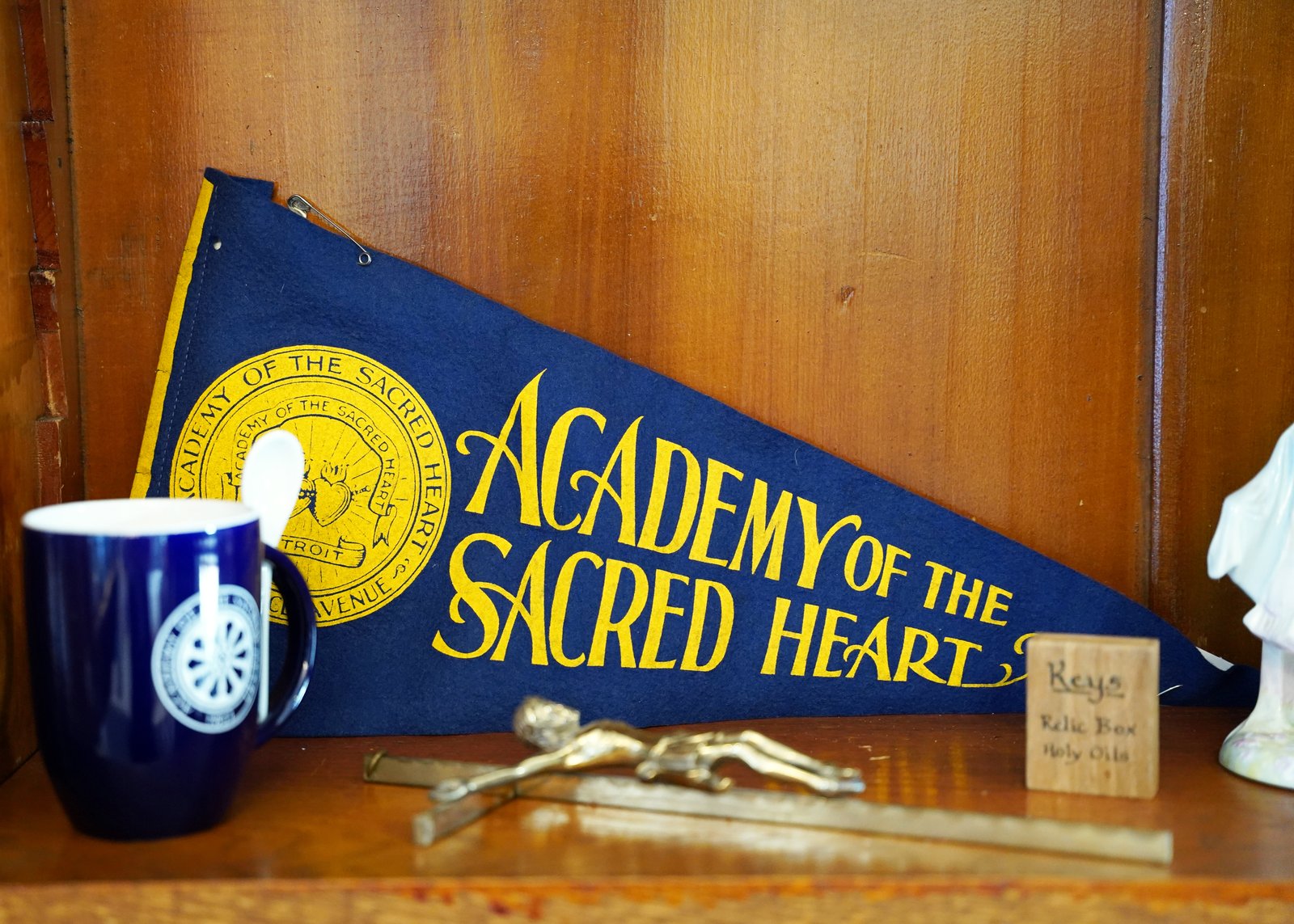 Reminders of the school's history can be seen across the campus, such as this vintage school pendant located in the school's front parlor. (Photo by Gabriella Patti | Detroit Catholic)