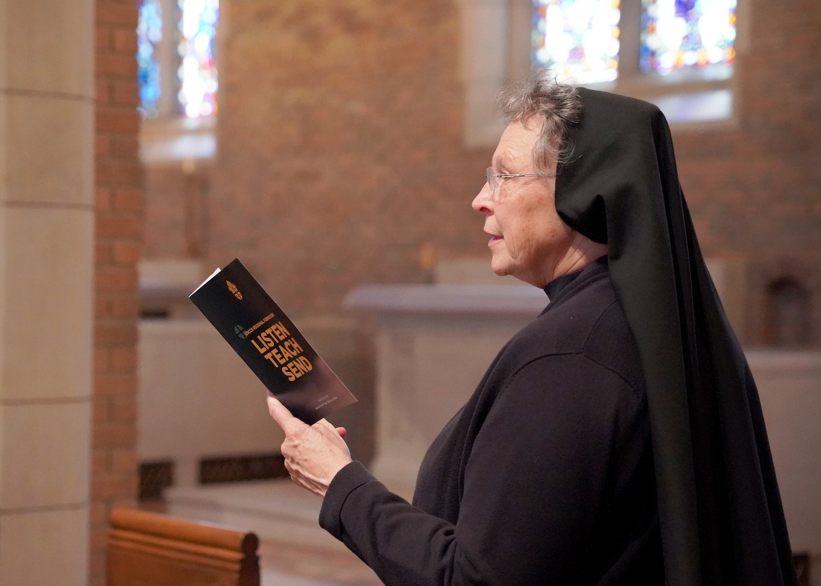 Sr. Esther Mary Nickel, RSM, associate director for sacred worship in the Department of Evangelization and Missionary Discipleship, prays during Mass with the archbishop.