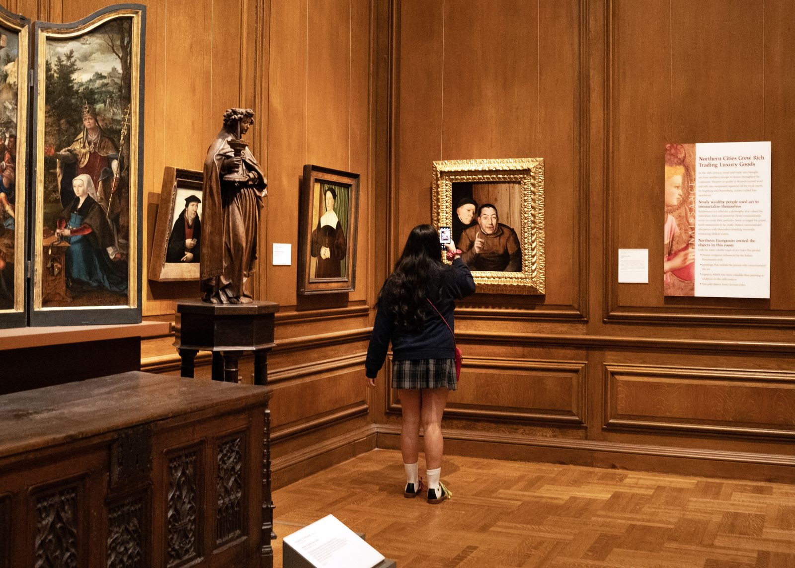 A Regina student takes a picture of one of the works of art in the DIA. Regina students spent a day at the DIA first to visit the ofrendas and then to tour the rest of the art museum Oct. 24.