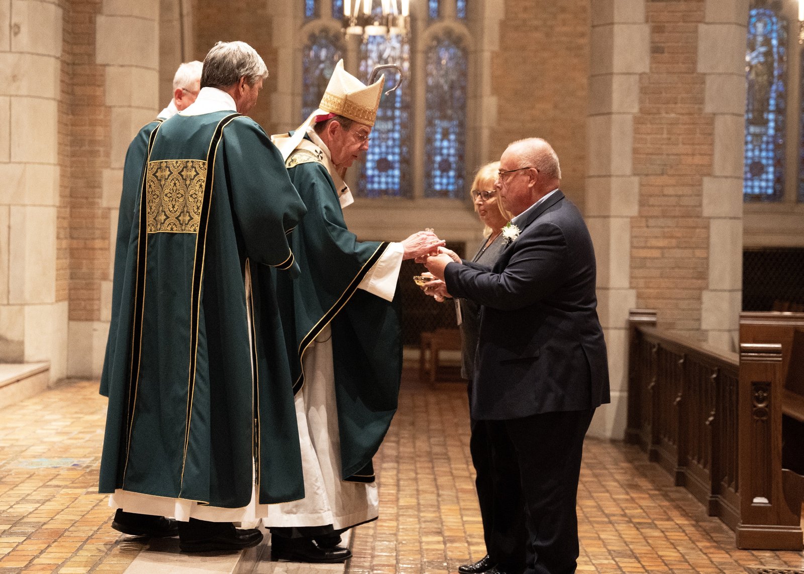 Archbishop Allen H. Vigneron accepts the gifts during a special Mass honoring deacon jubilarians and their wives Oct. 29 at Sacred Heart Major Seminary.