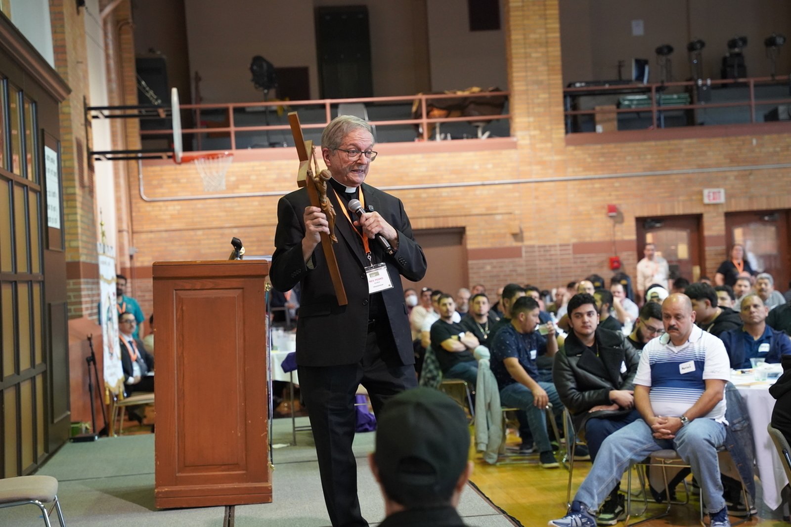 Fr. Núñez holds a crucifix as he gives one of his two presentations.