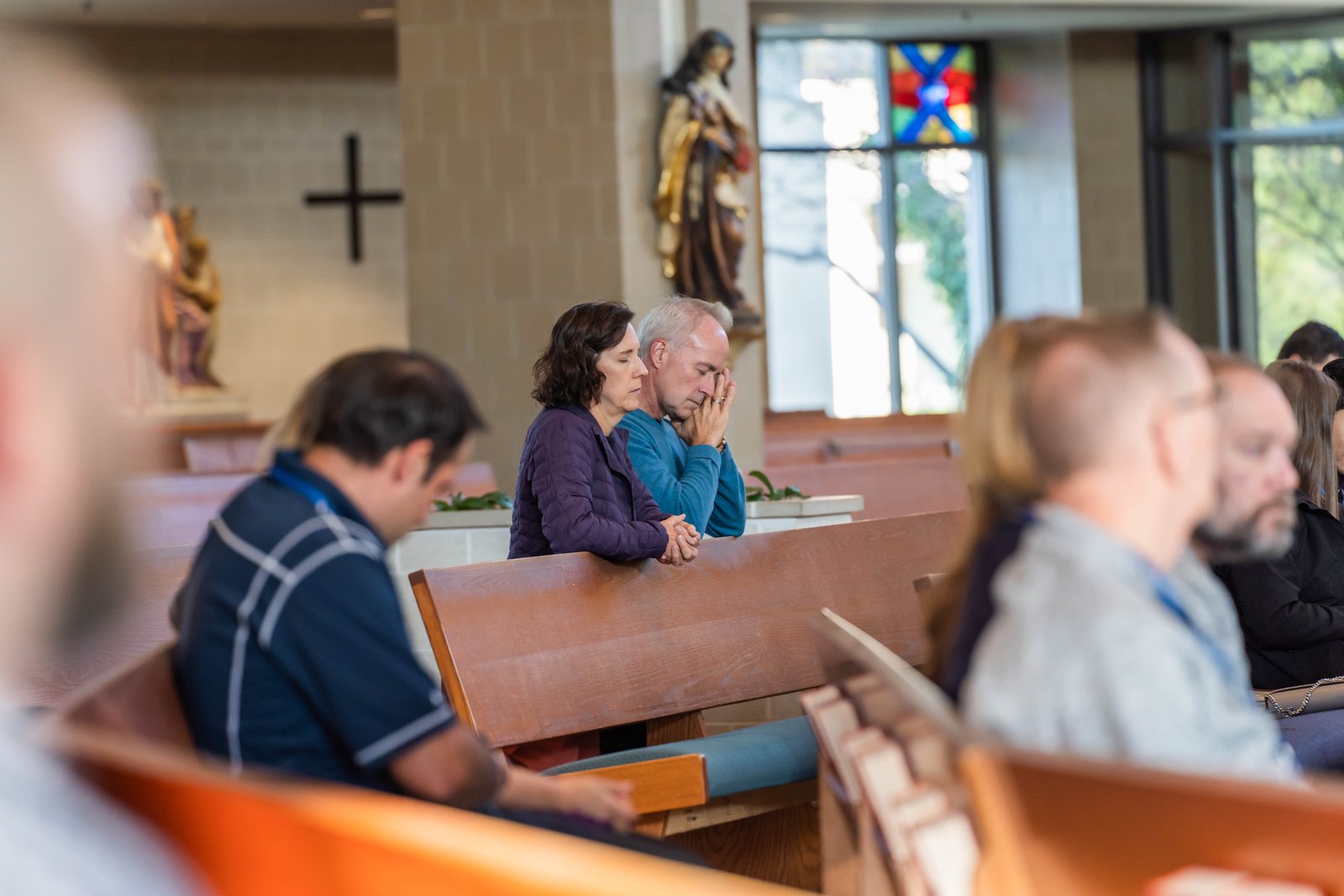 Cheryl and David Trost of St. John Neumann Parish in Canton pray together during the conference.