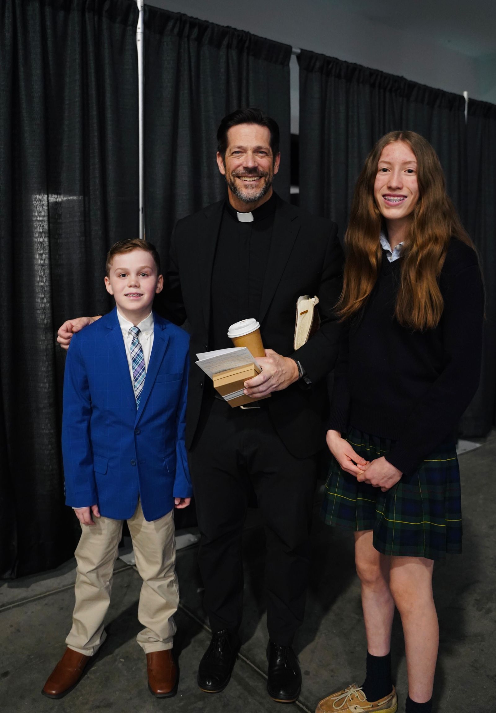 Lucia Smith, an eighth-grader from St. Mary Catholic School in Royal Oak, and Theodore Howell, a fifth-grader from St. Patrick School in Carlton, met Fr. Schmitz during the end of the conference.
