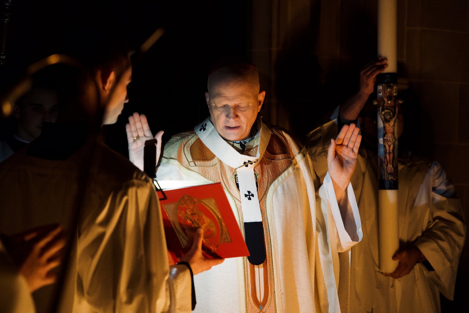Archbishop Edward J. Weisenburger blesses the Easter fire outside the Cathedral of the Most Blessed Sacrament to begin the Easter Vigil Mass on Saturday, April 4.