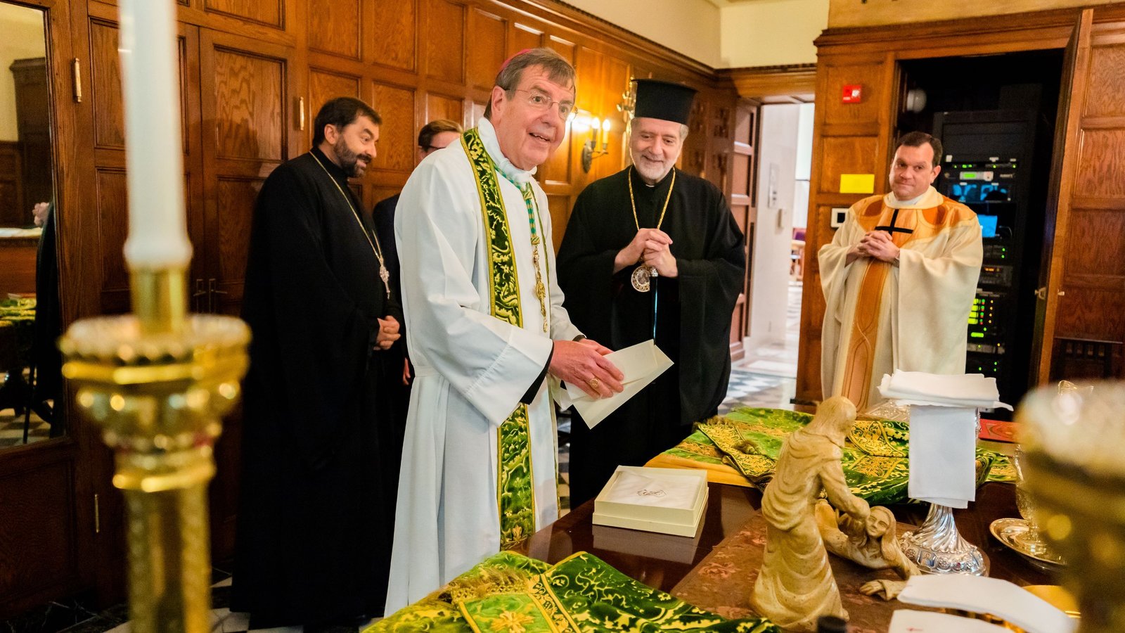 Archbishop Vigneron smiles during a reception with Greek Orthodox Metropolitan Nicholas in the sacristy of the Cathedral of the Most Blessed Sacrament during a celebration for his 25th episcopal jubilee on July 11, 2021. (Valaurian Waller | Detroit Catholic)