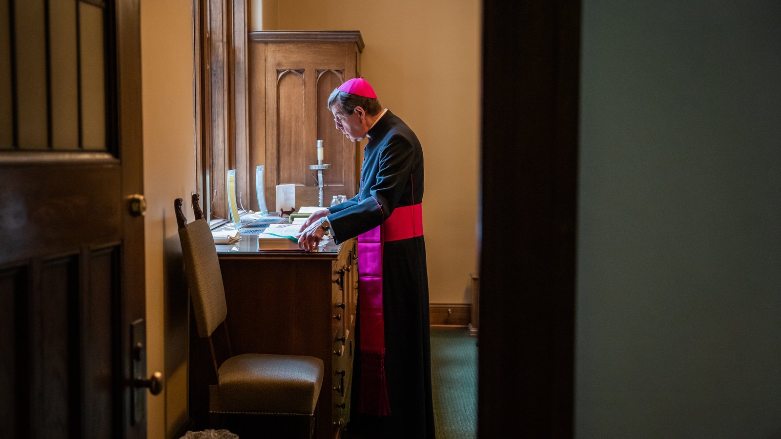 Archbishop Vigneron takes a quiet moment to himself in the sacristy at Sacred Heart Major Seminary while preparing to celebrate the seminary's commencement Mass on April 29, 2023. (Valaurian Waller | Detroit Catholic)