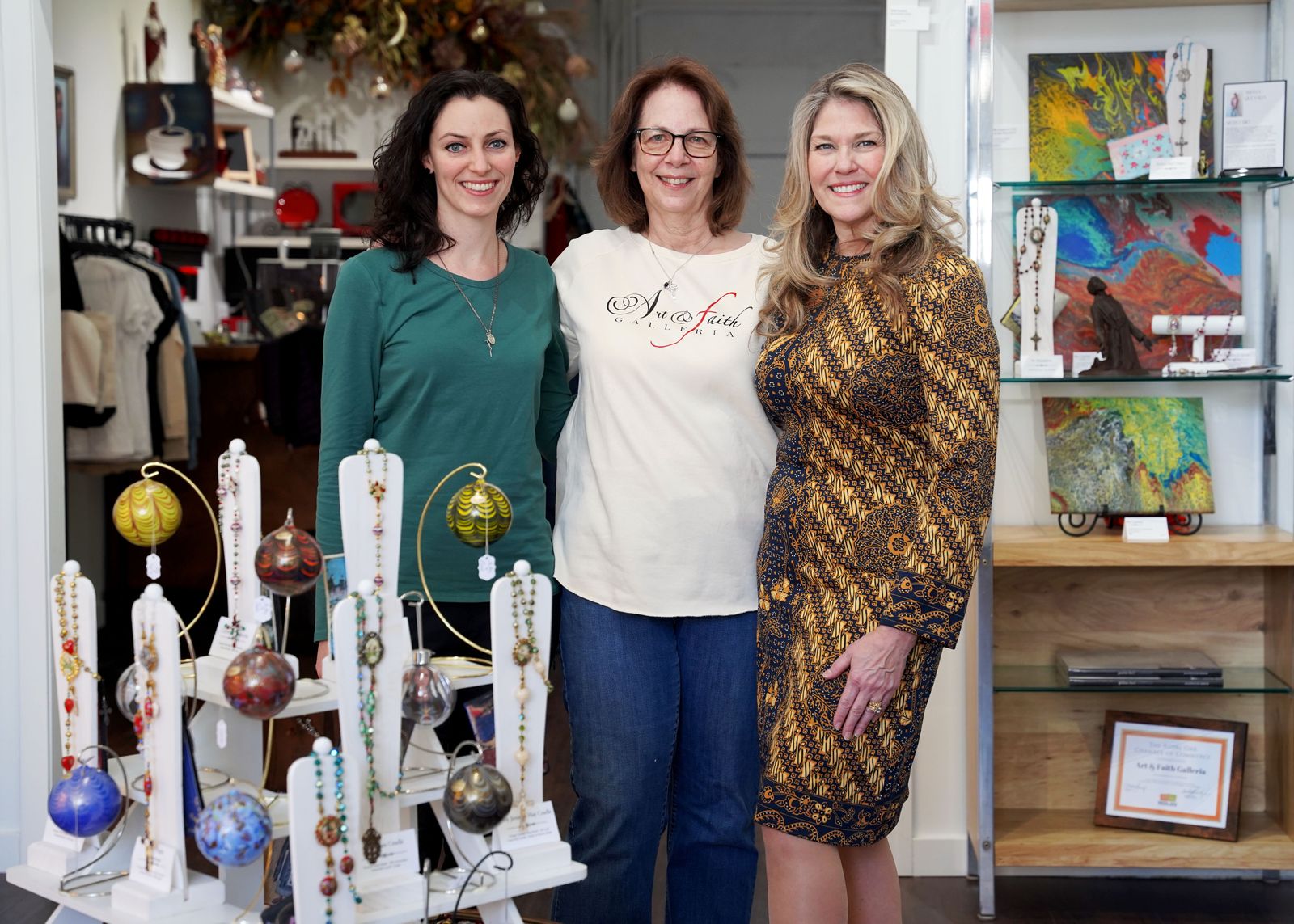 From left to right, artist Mary Dudek, Susan Perrish and Jeannette Quesada stand in the center of the galleria.
