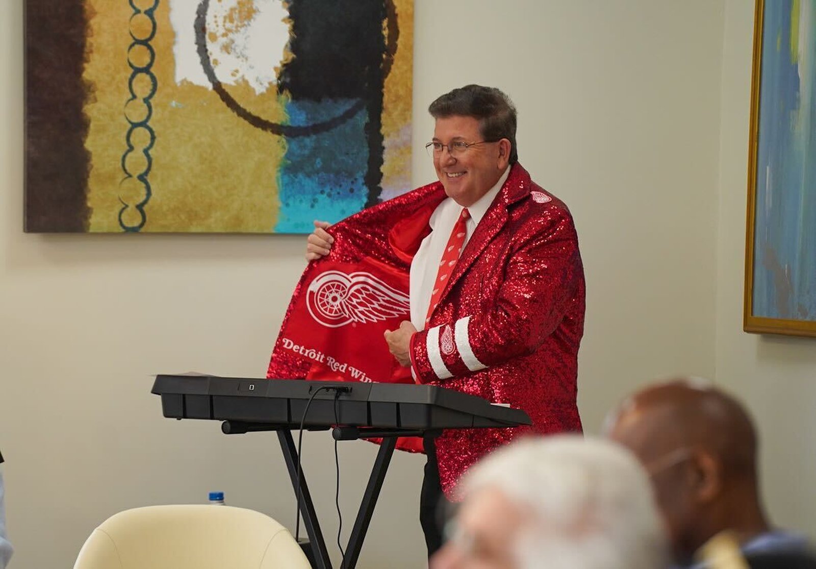 Detroit Red Wings organist Lance Luce offers some joviality to the day's proceedings, playing warm-up music before each speaker took the podium.