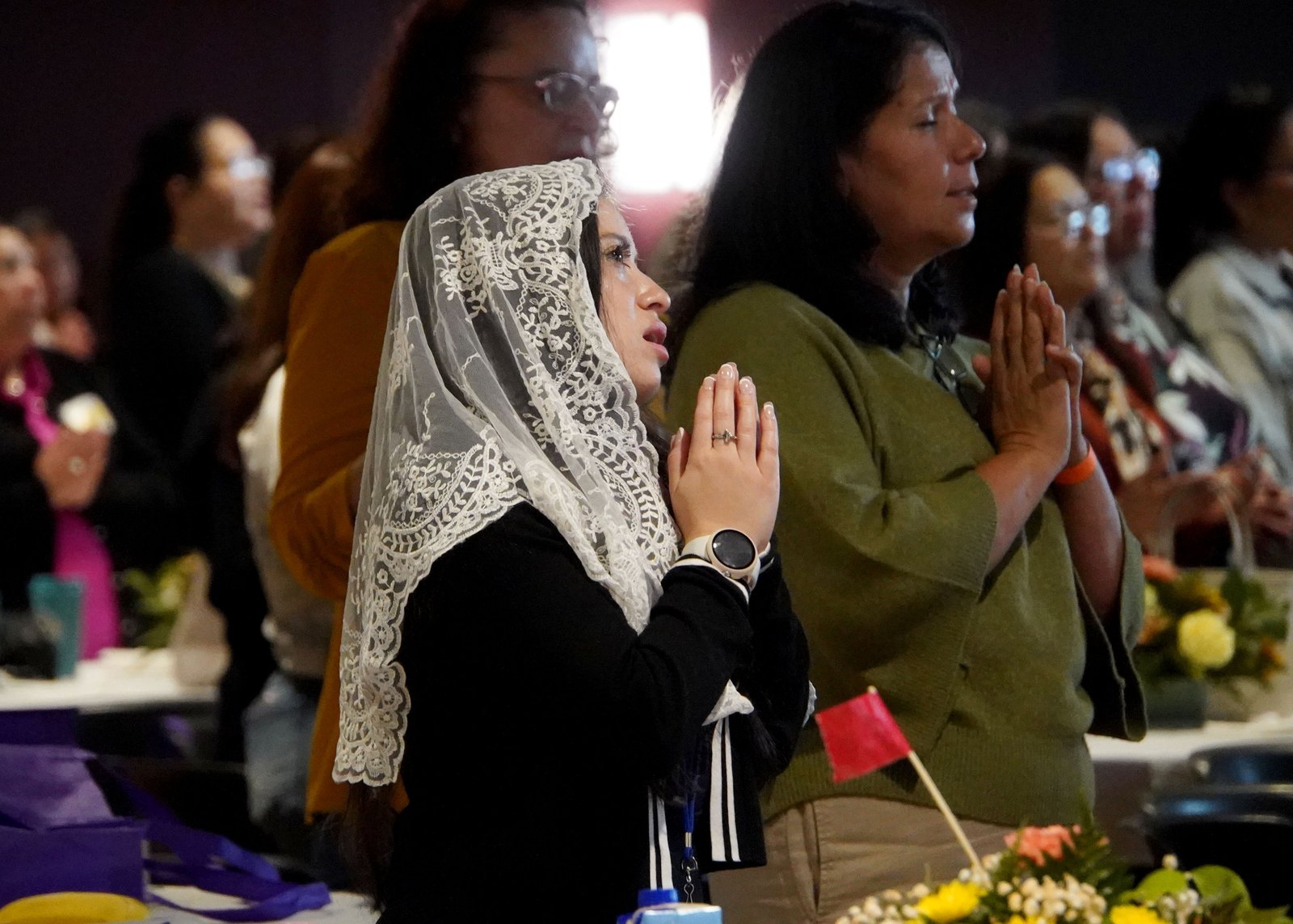 Conference-goers pray during one of the sessions. The conference included Mass, Eucharistic adoration and praise-and-worship experiences.