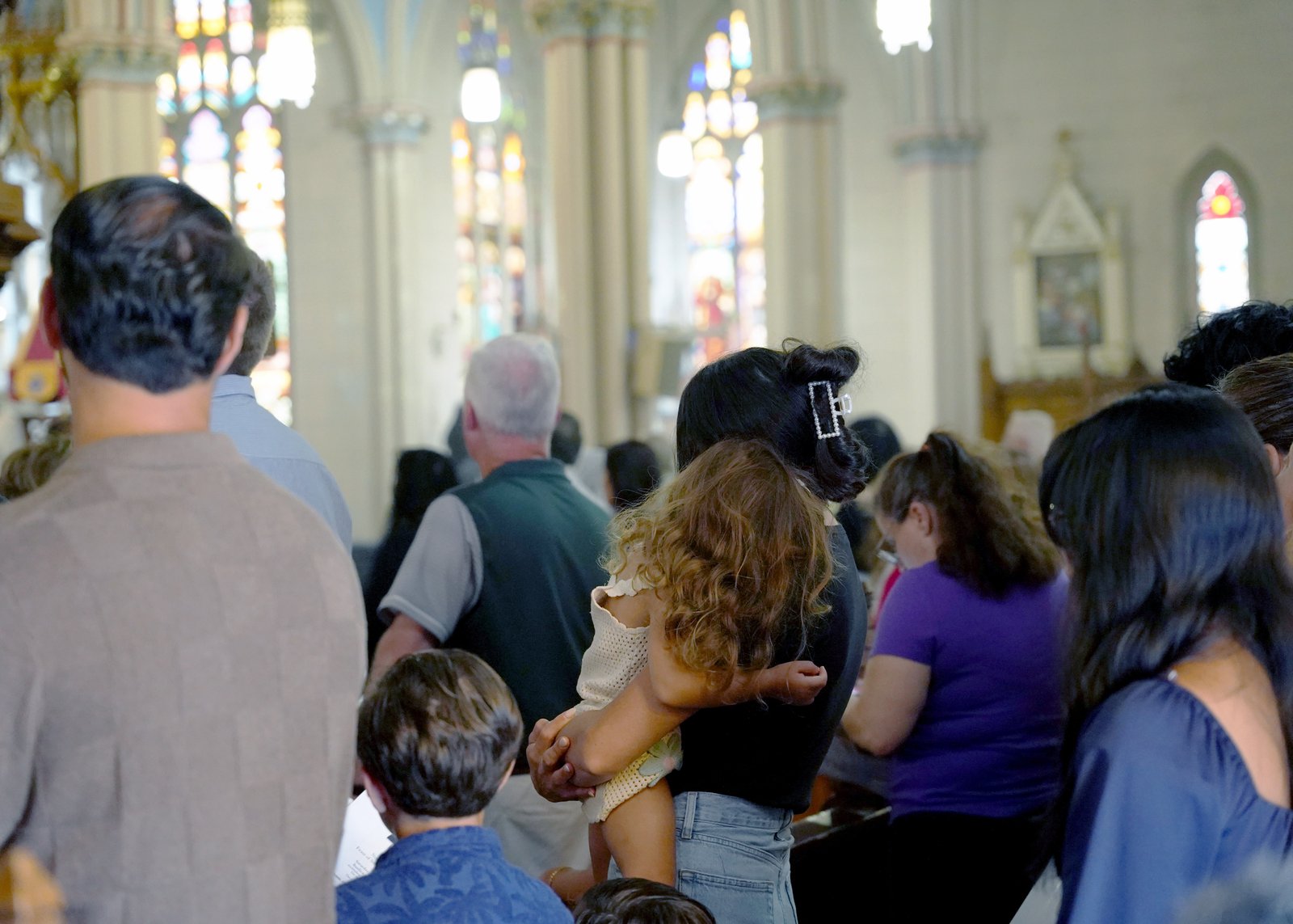 Families attend the feast day Mass at the Basilica of Ste. Anne in southwest Detroit on Saturday, July 26.