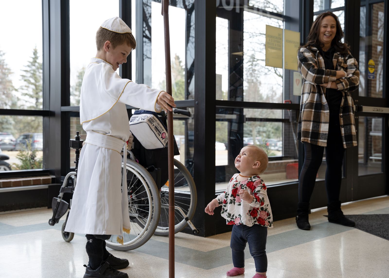 Pope Donovan "blesses" his younger sister as he processes through Everest Academy after being elected by his peers. The procession takes place each year of the Feast of the Chair of St. Peter.