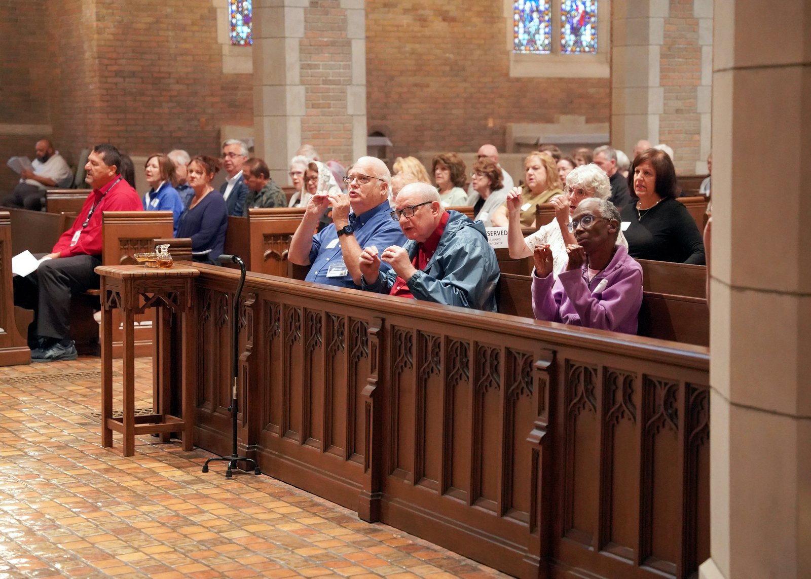 The event included liturgical ministers from across the Archdiocese, including members of the St. John's Deaf Center, pictured here signing the responses during Mass.