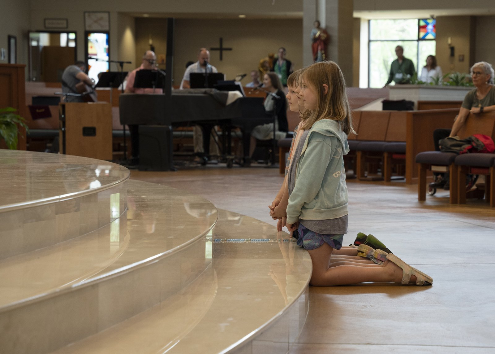 During the two-hour "Praise Fest," parishioners filled the church, worshipping in adoration and participating in an indoor Eucharistic procession. Young children knelt on the steps of the altar to be as close to Jesus as possible, and praise and worship music was played. (Gabriella Patti | Detroit Catholic)