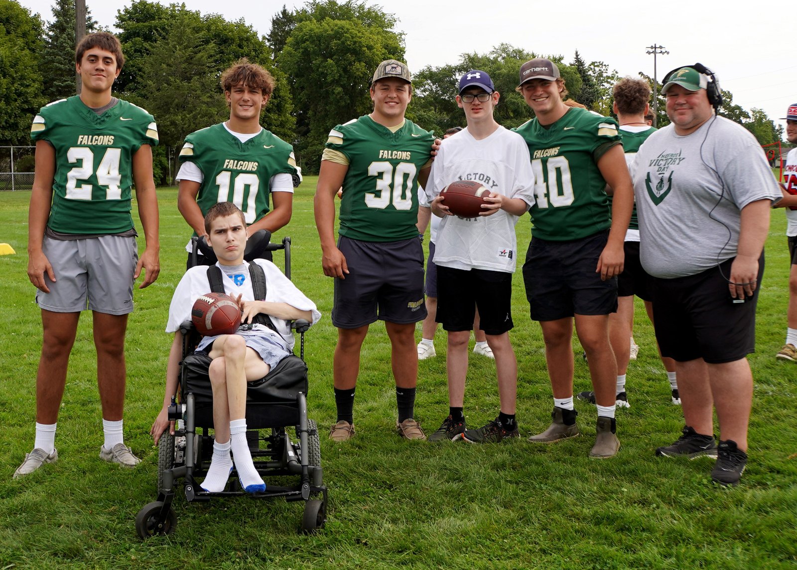 Kyle McElvany, standing on the far right, is the director of Monroe Victory Day and the director of inclusion and assistant football coach at St. Mary Catholic Central High School.