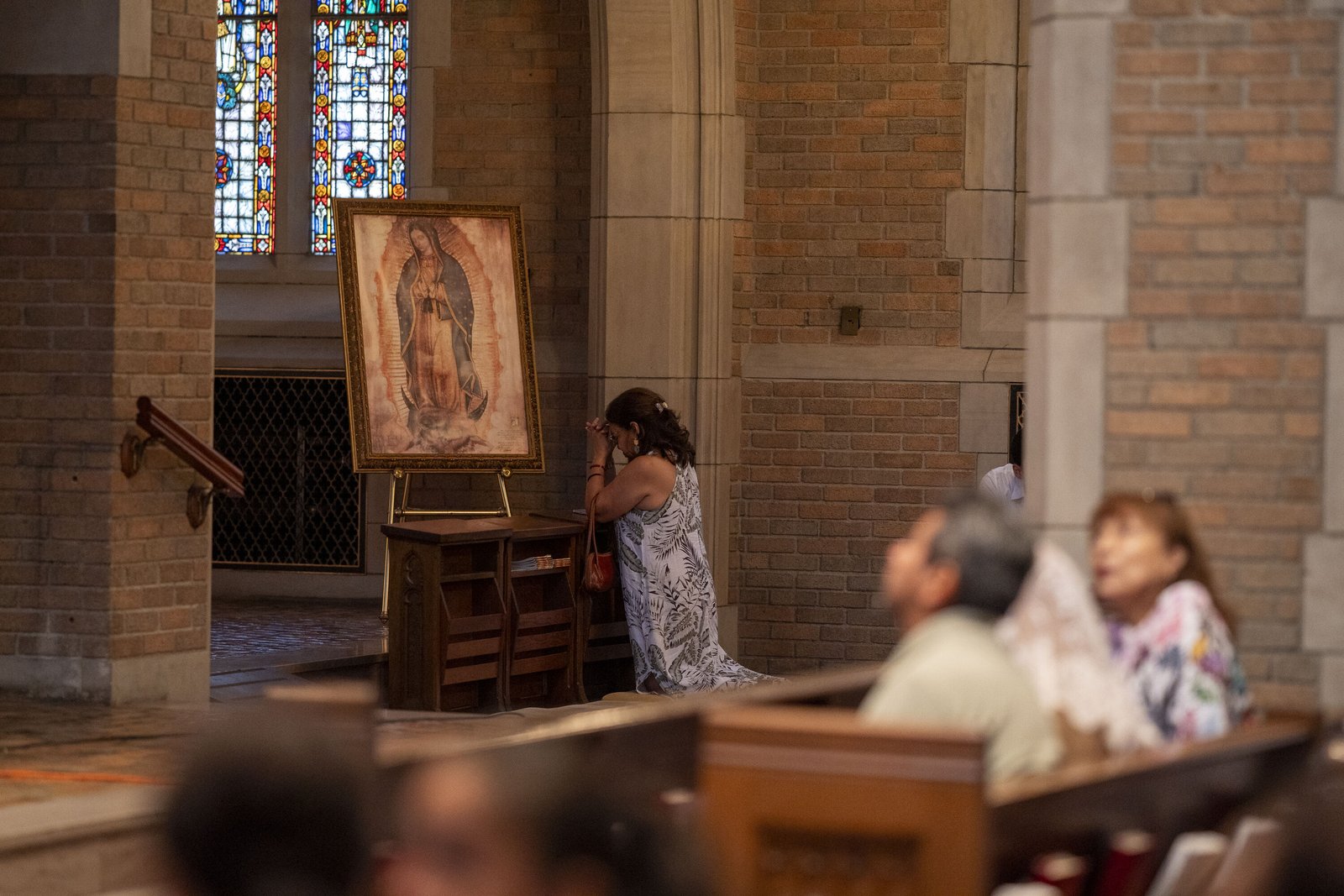 A woman prays before an image of Our Lady of Guadalupe in the chapel of Sacred Heart Major Seminary. The image of Our Lady of Guadalupe is filled with many signs and symbols of significance for the Aztec people, who would know who Our Lady is from her appearance.