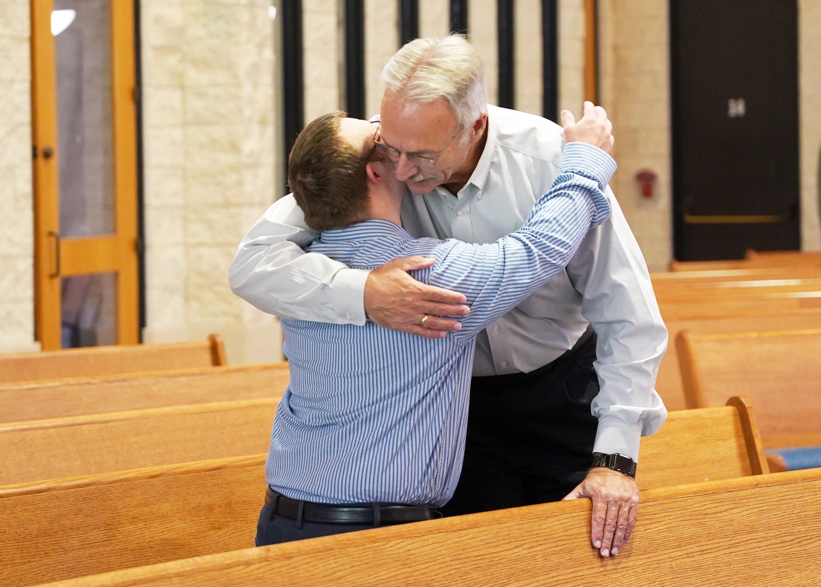 Robby receives a warm embrace from his father, Charles Heil, who said his mission is to "make Robby a saint," he said.