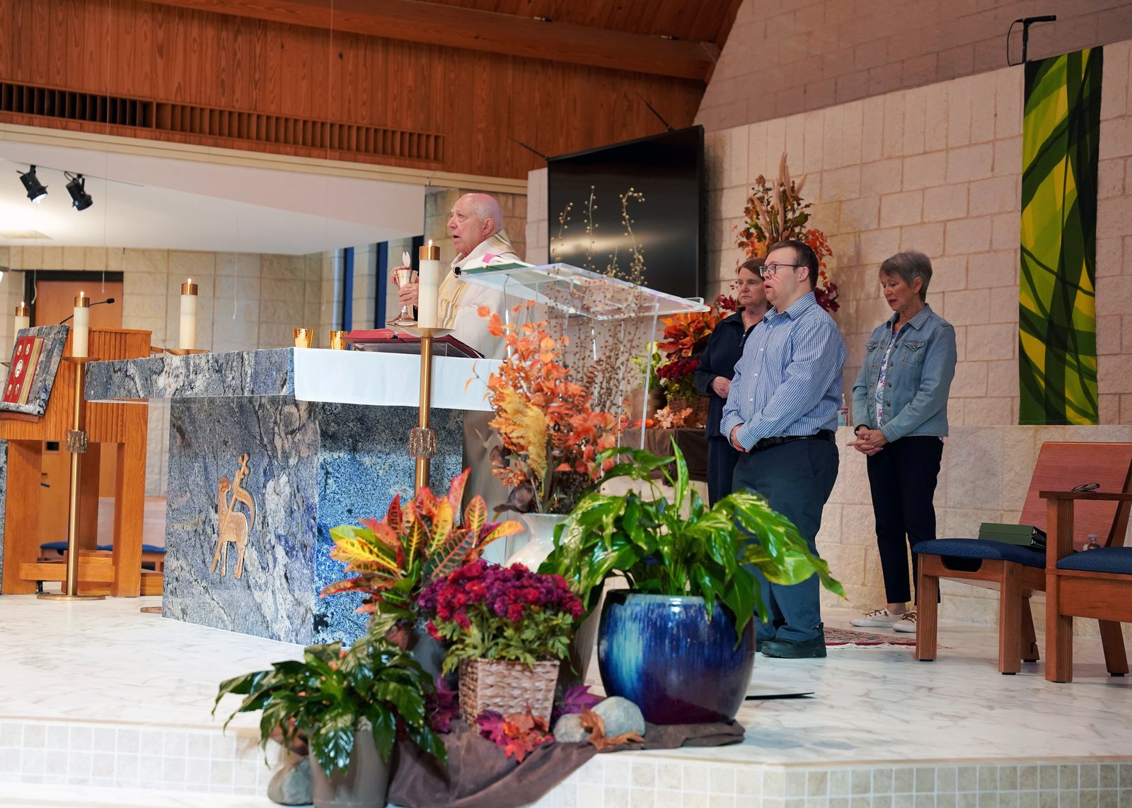 Robby Heil prepares to assist Fr. Zaorski with distribution Communion at St. James Parish in Novi.