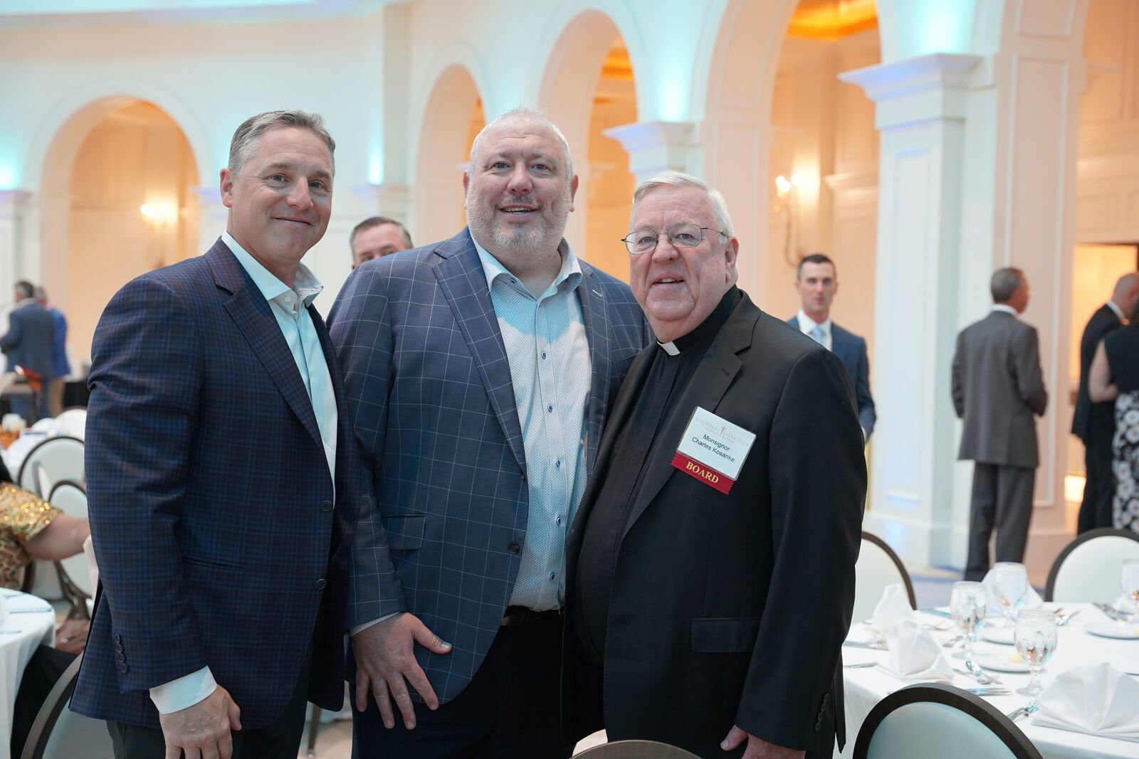 Msgr. Charles Kosanke, chairman of the board of Catholic Charities of Southeast Michigan, talks with benefactors, supporters and volunteers during CCSEM's gala dinner.