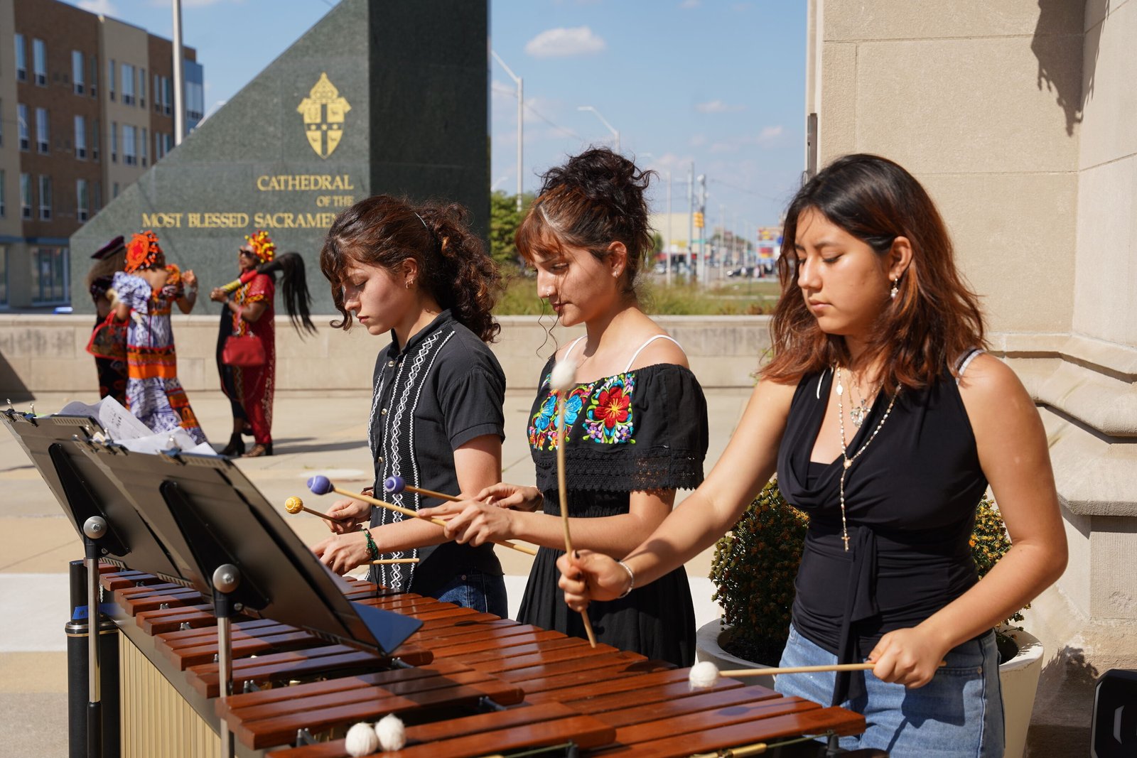 Students play music in the plaza of the Cathedral of the Most Blessed Sacrament following the Jubilee of Migrants Mass on Oct. 5.