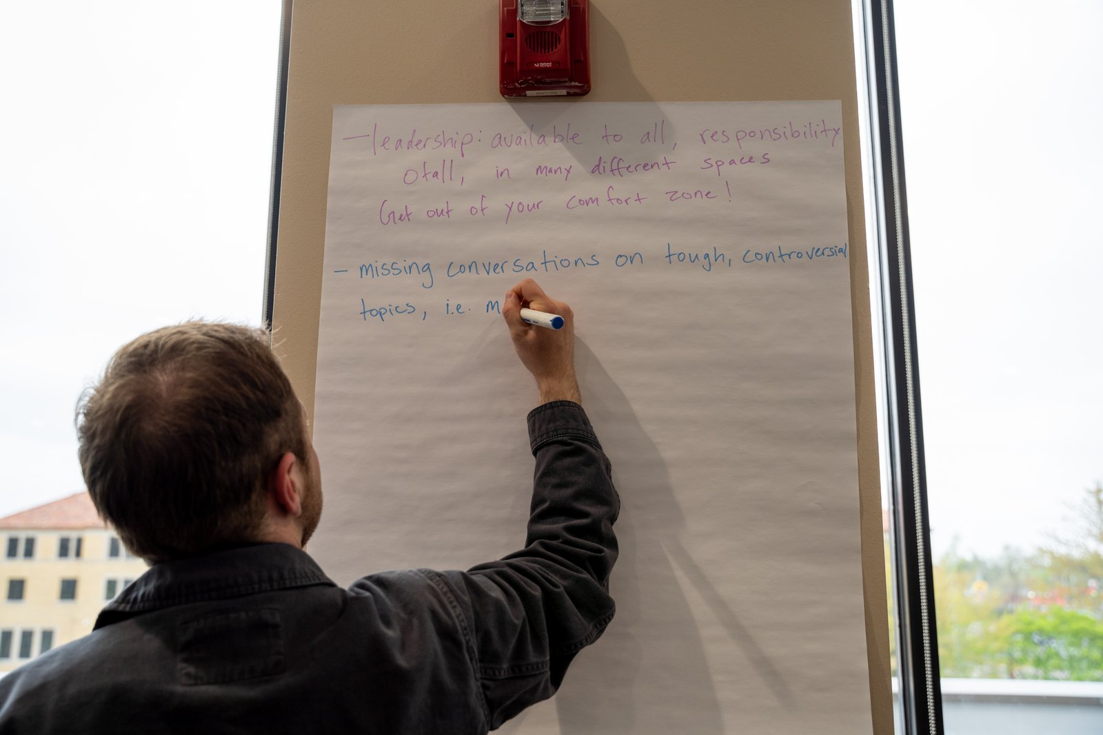 A table scribe takes notes during the discussion portion of the afternoon. Participants spoke about a variety of topics, including the need to be a more welcoming Church attentive to the needs of oppressed and vulnerable communities.