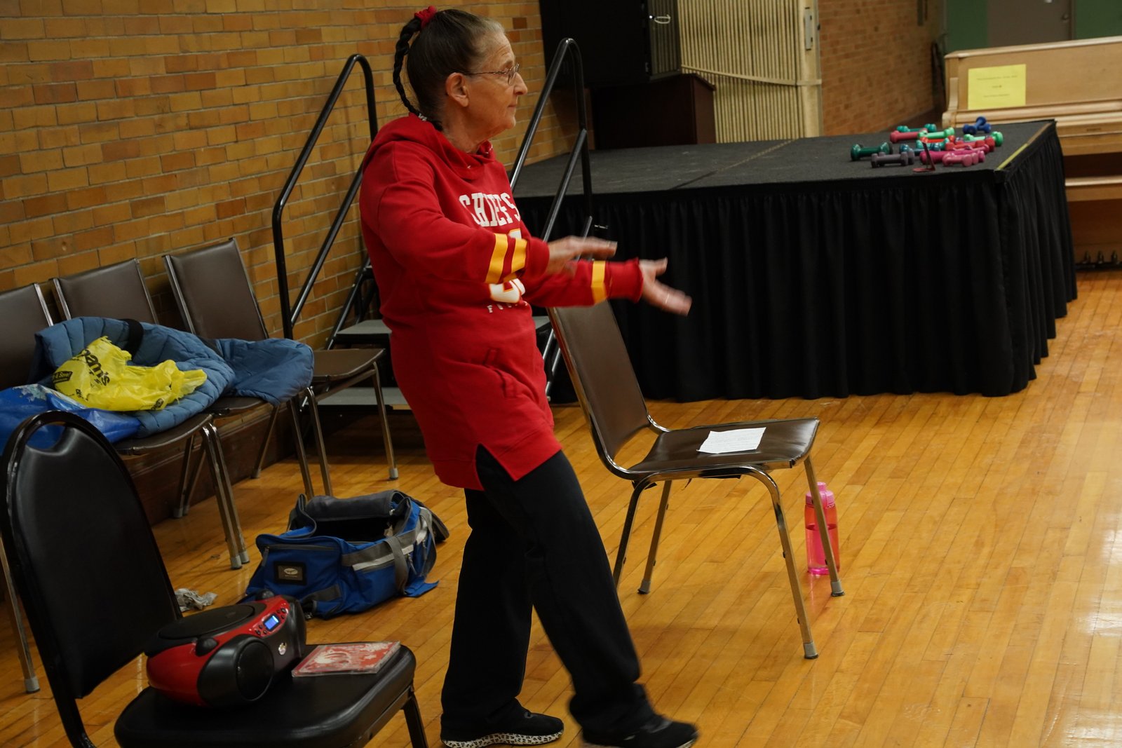 Linda Hoas, a local fitness instructor, leads the exercise classes at St. Louis Parish, often playing music while leading the group of 40 to 50 people through various routines.