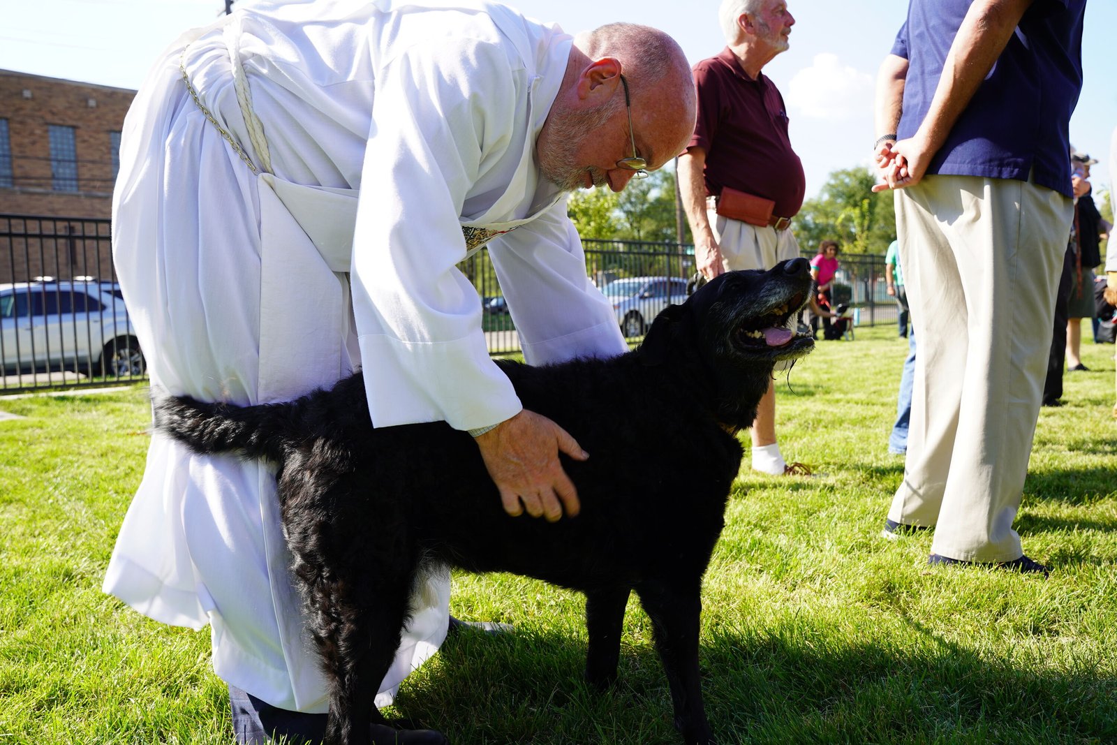 Deacon Christopher Jaskowiec helped bless pets and people who attended the opening of the park, including Fr. Mech's dog, Annie.