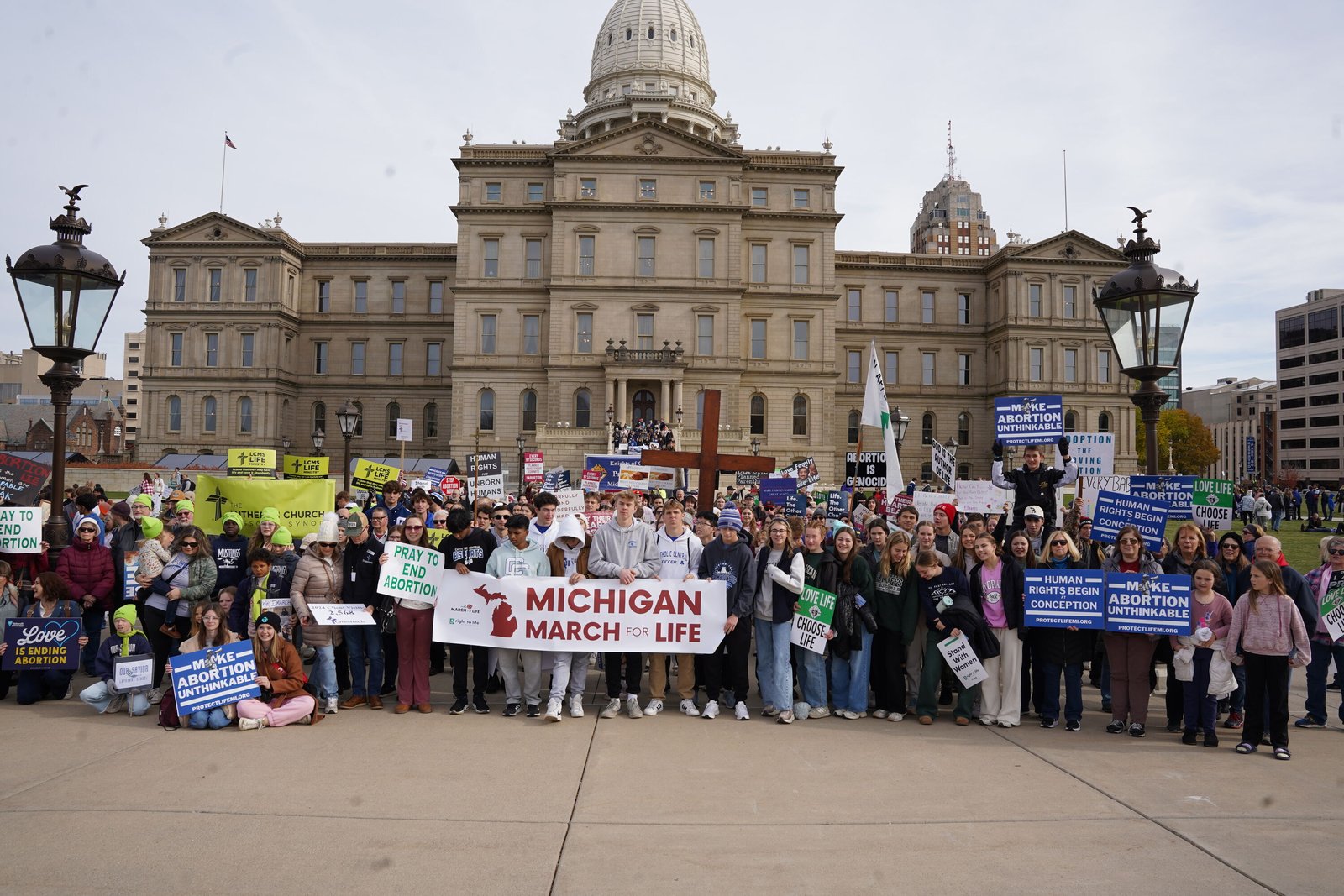 High school students pose for a group picture in front of the Michigan state Capitol building in Lansing, where the Michigan March for Life took place.