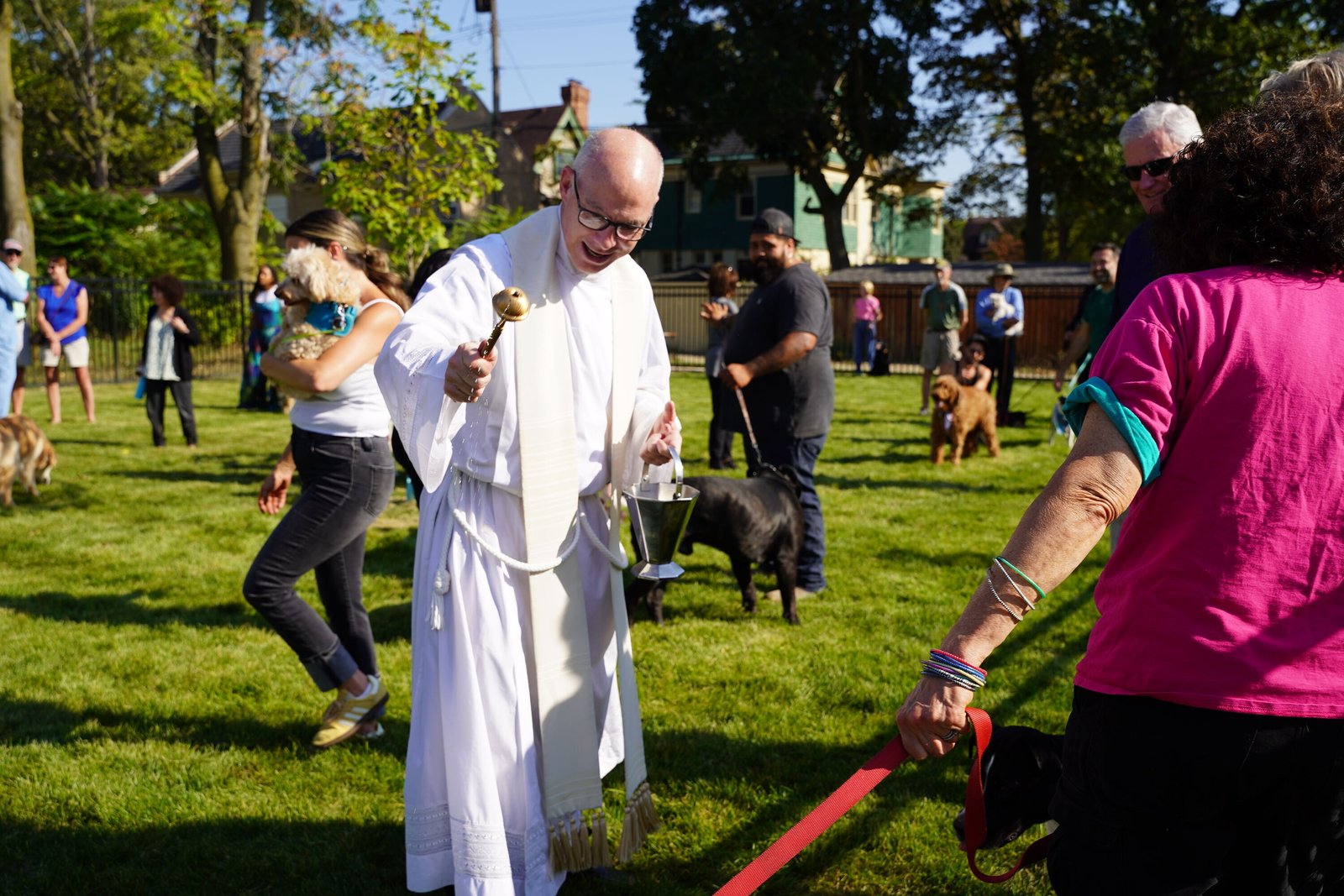 Fr. J.J. Mech blesses pets and their owners Oct. 4, the feast of St. Francis of Assisi, during the grand opening of the new Holy Paws Dog Park.